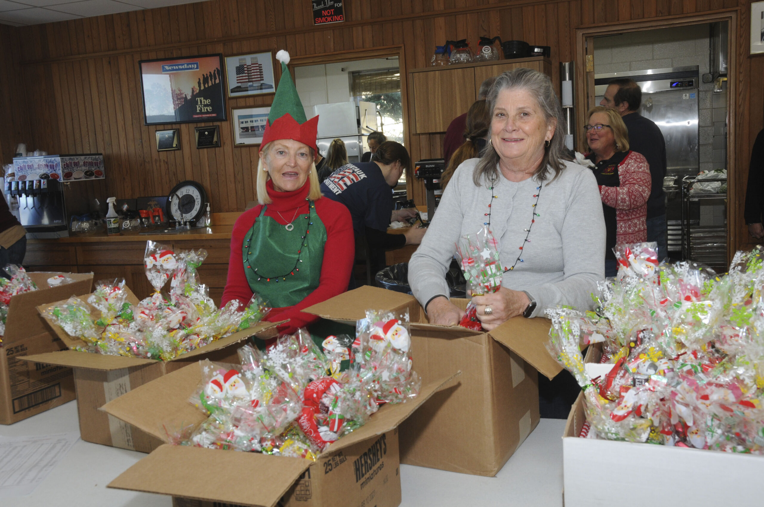 Elise Prado and Debbie Kennedy at the Montauk Fire Department's annual dinner for Seniors on Sunday. Equipment bays were cleared out to make room for festive dinner tables. MFD volunteers handed out 