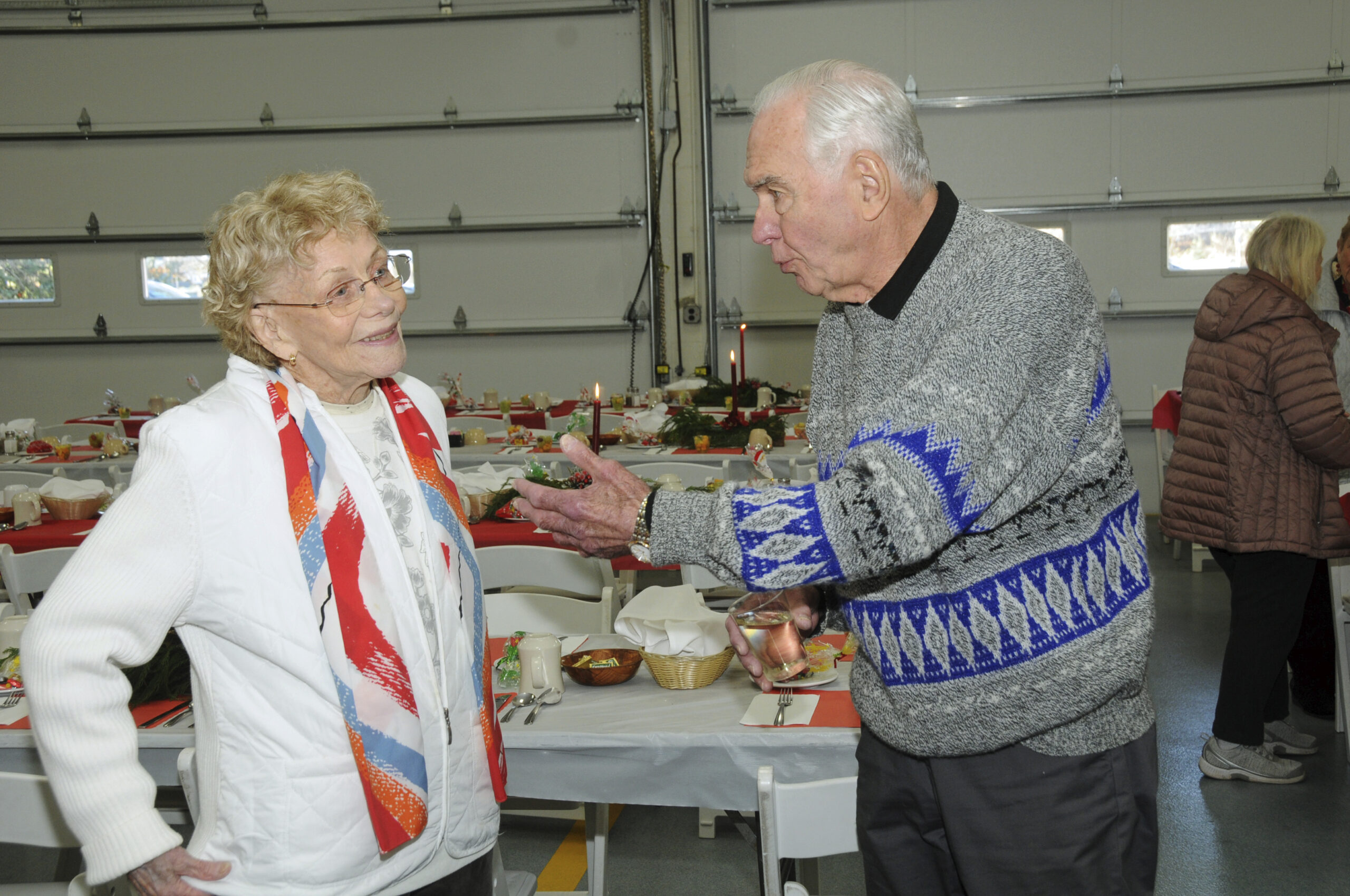 Helen Giustino and Herb Mocbeichel at the Montauk Fire Department's annual dinner for Seniors on Sunday. Equipment bays were cleared out to make room for festive dinner tables. MFD volunteers handed out 