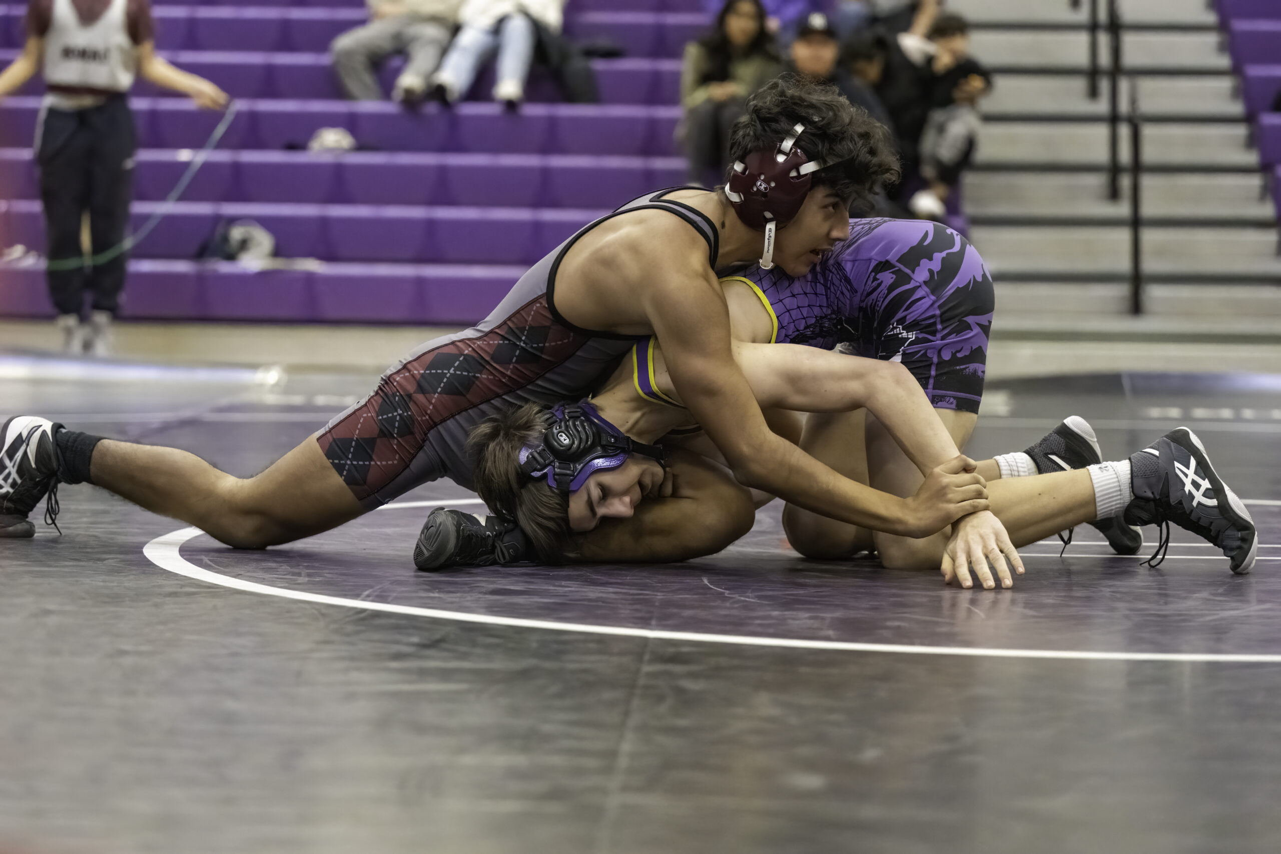 East Hampton's Esteban Velez works with his Hamptons Bays opponent.  MARIANNE BARNETT