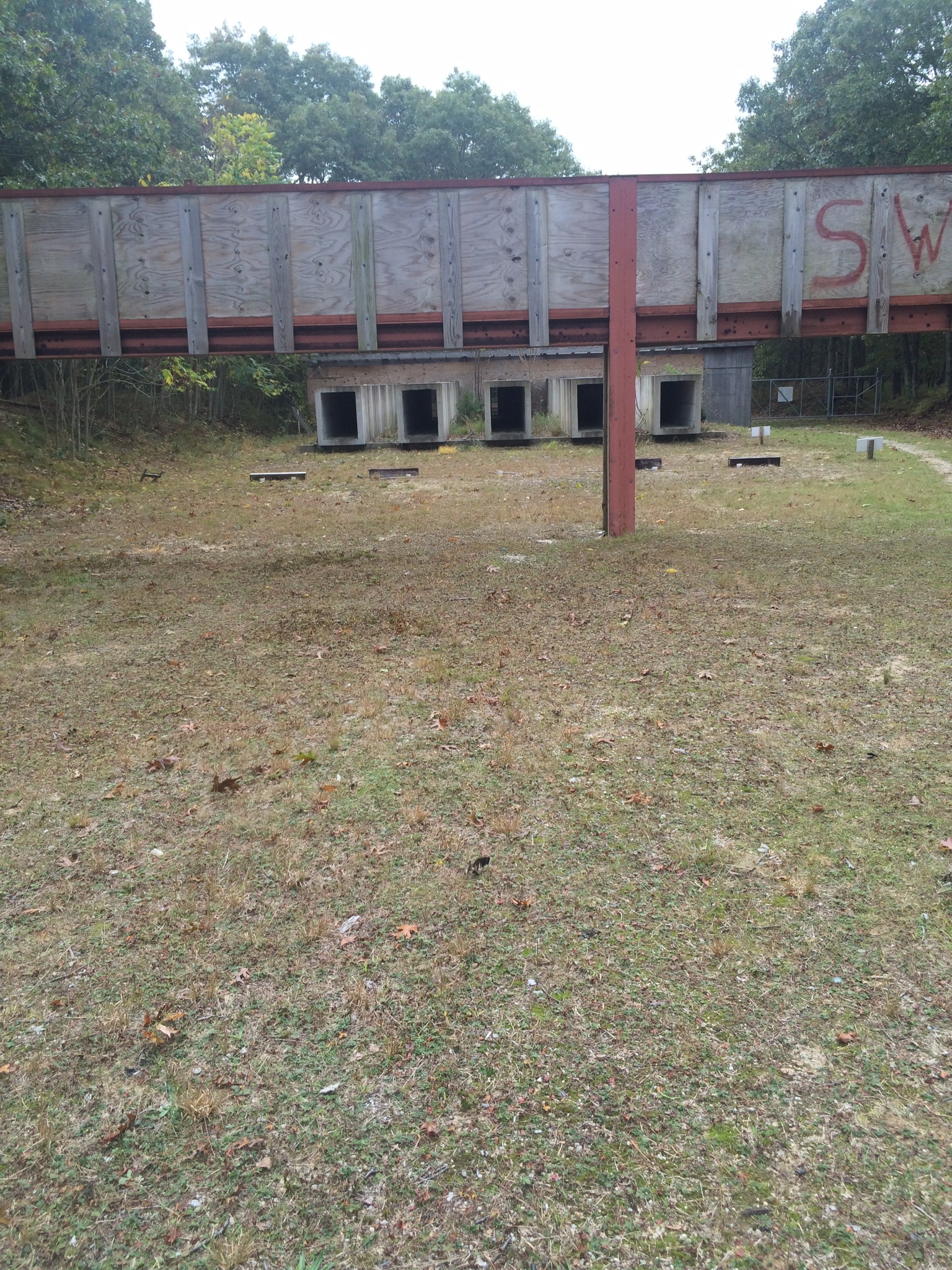 The shooting range at the Maidstone Gun Club from the target's view. At the end of the concrete shooting tunnels there is a wood shield intended to prevent errant or ricocheted bullets from exiting the range.