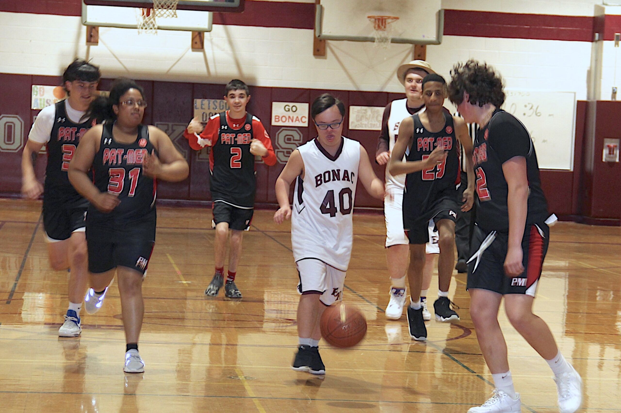 East Hampton High School student Sean Lester carries the ball up the court during a unified basketball game against Patchogue-Medford earlier this year. KYRIL BROMLEY