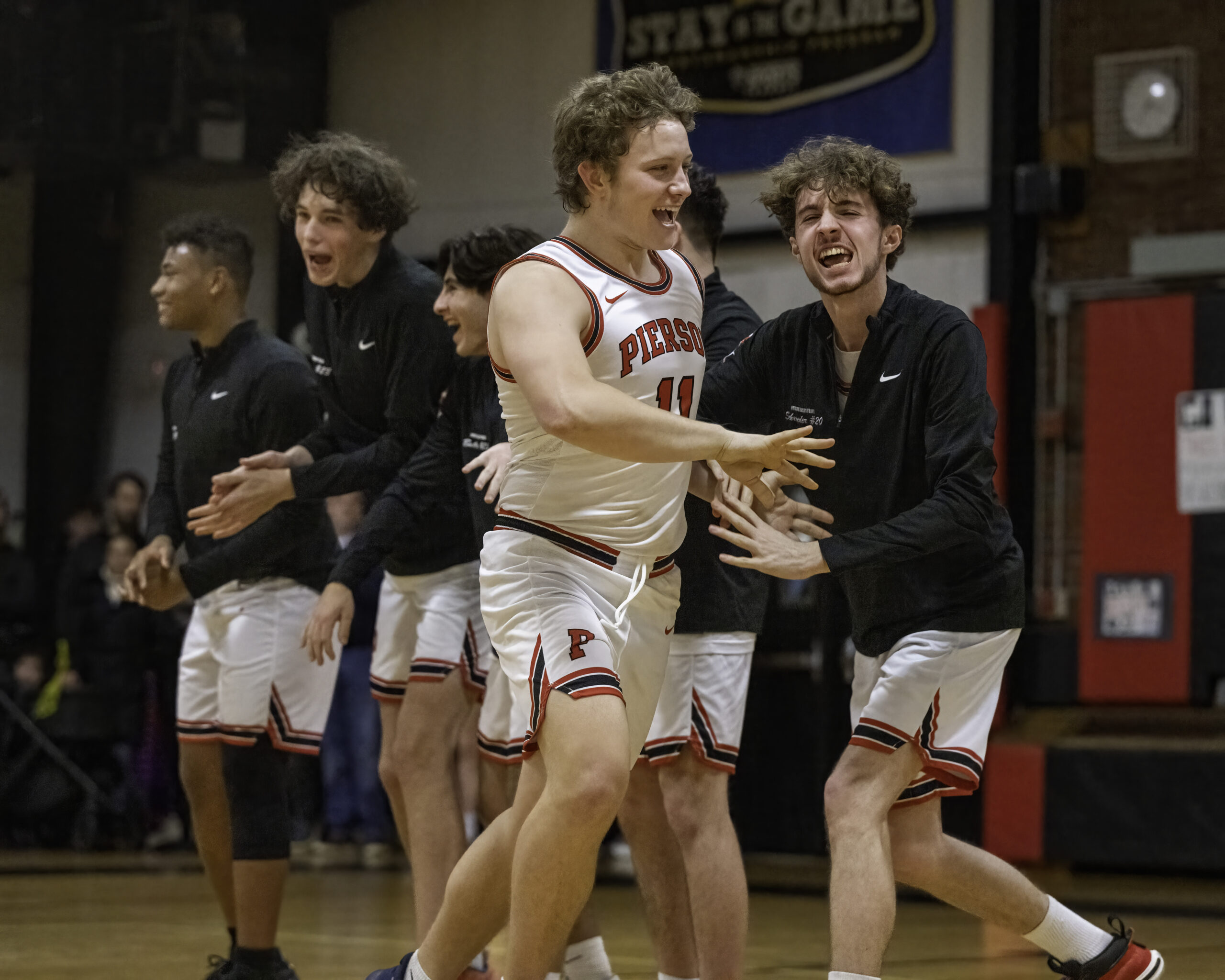 Pierson senior Logan Hartstein is pumped up and congratulated by teammates during player introductions prior to Friday night's game.   MARIANNE BARNETT