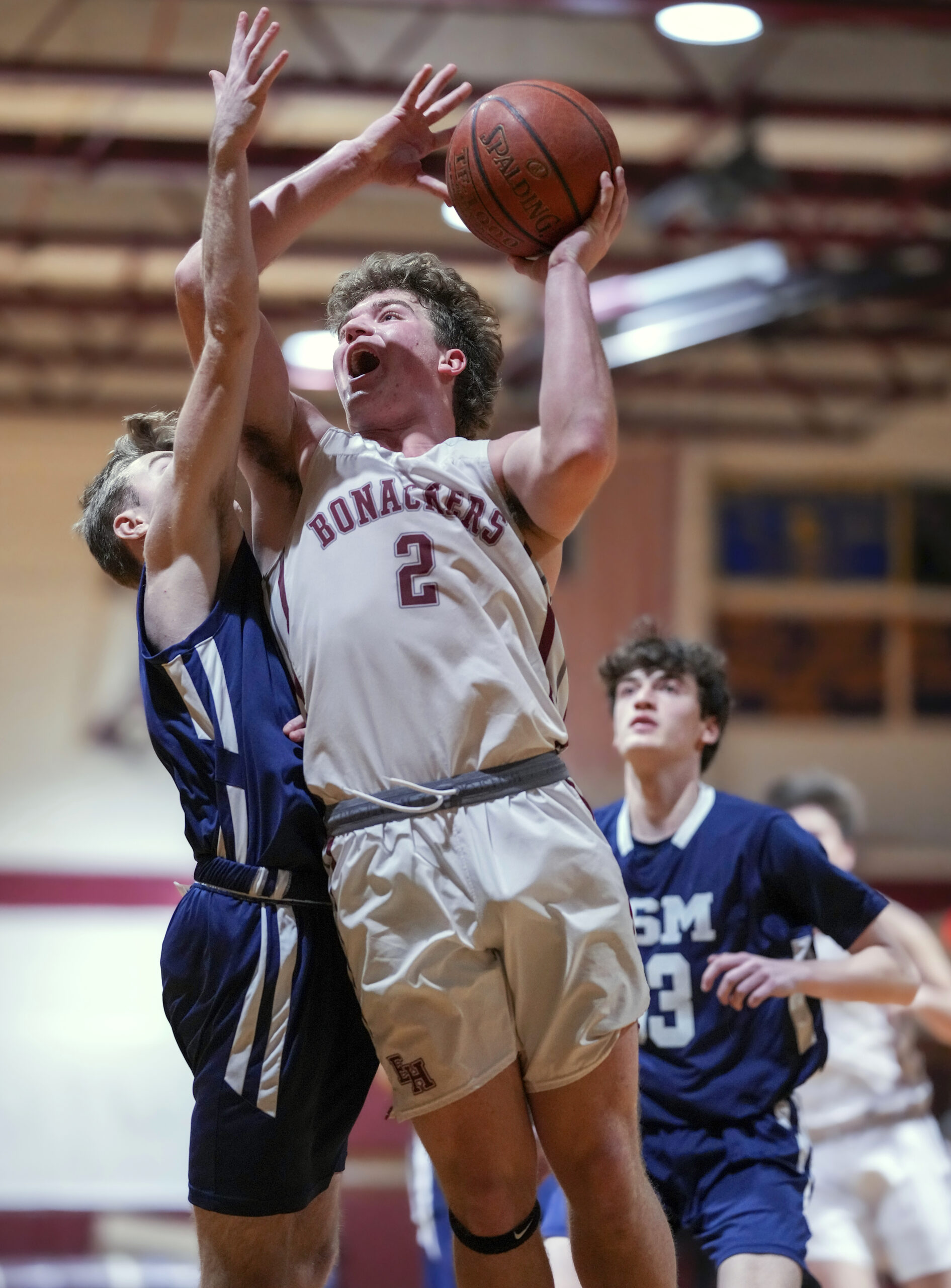 Senior Finn Byrnes muscles his way to the basket. RON ESPOSITO