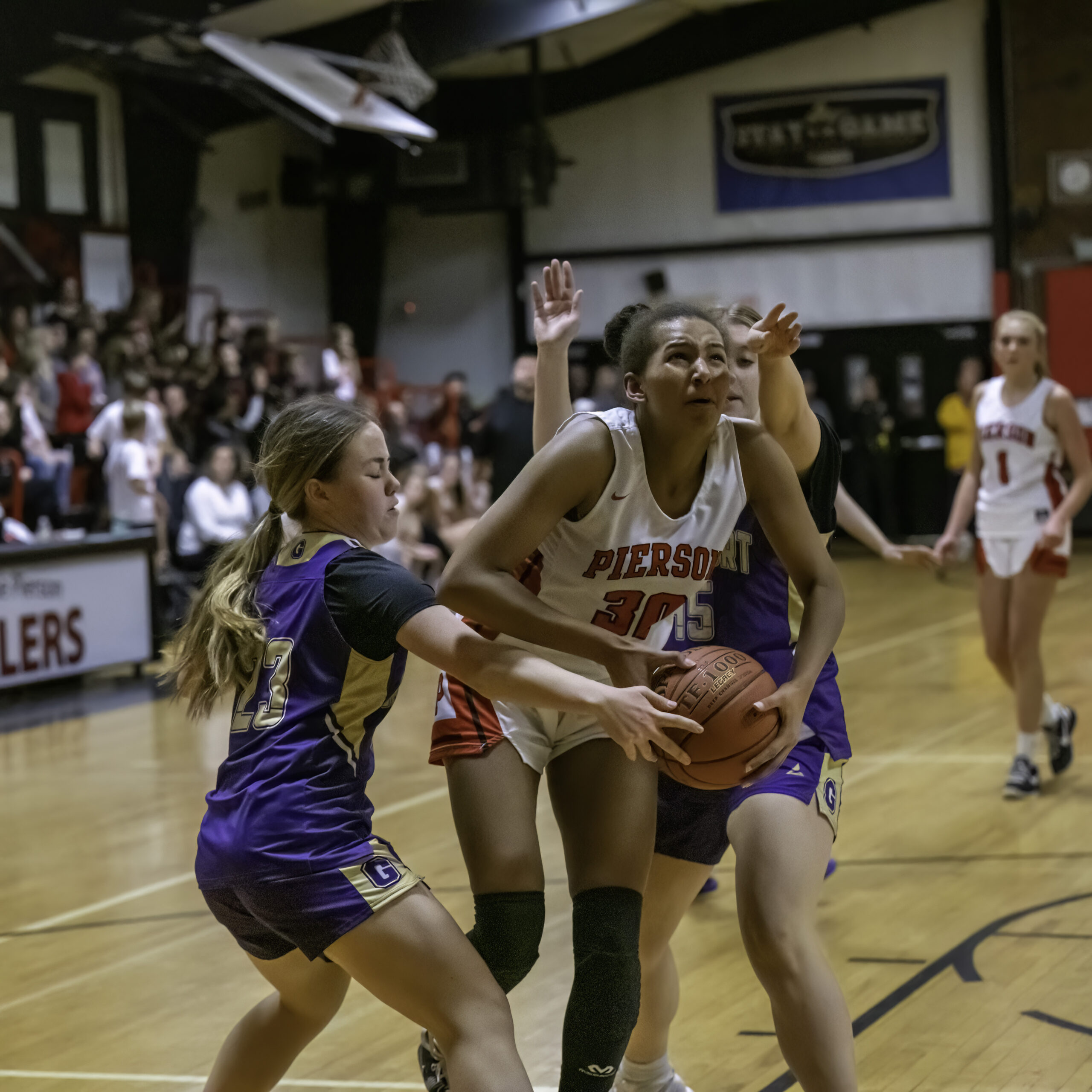 Pierson's Lyra Aubry, surrounded by a pair of Greenport/Southold players, tries to go up for two points.   MARIANNE BARNETT