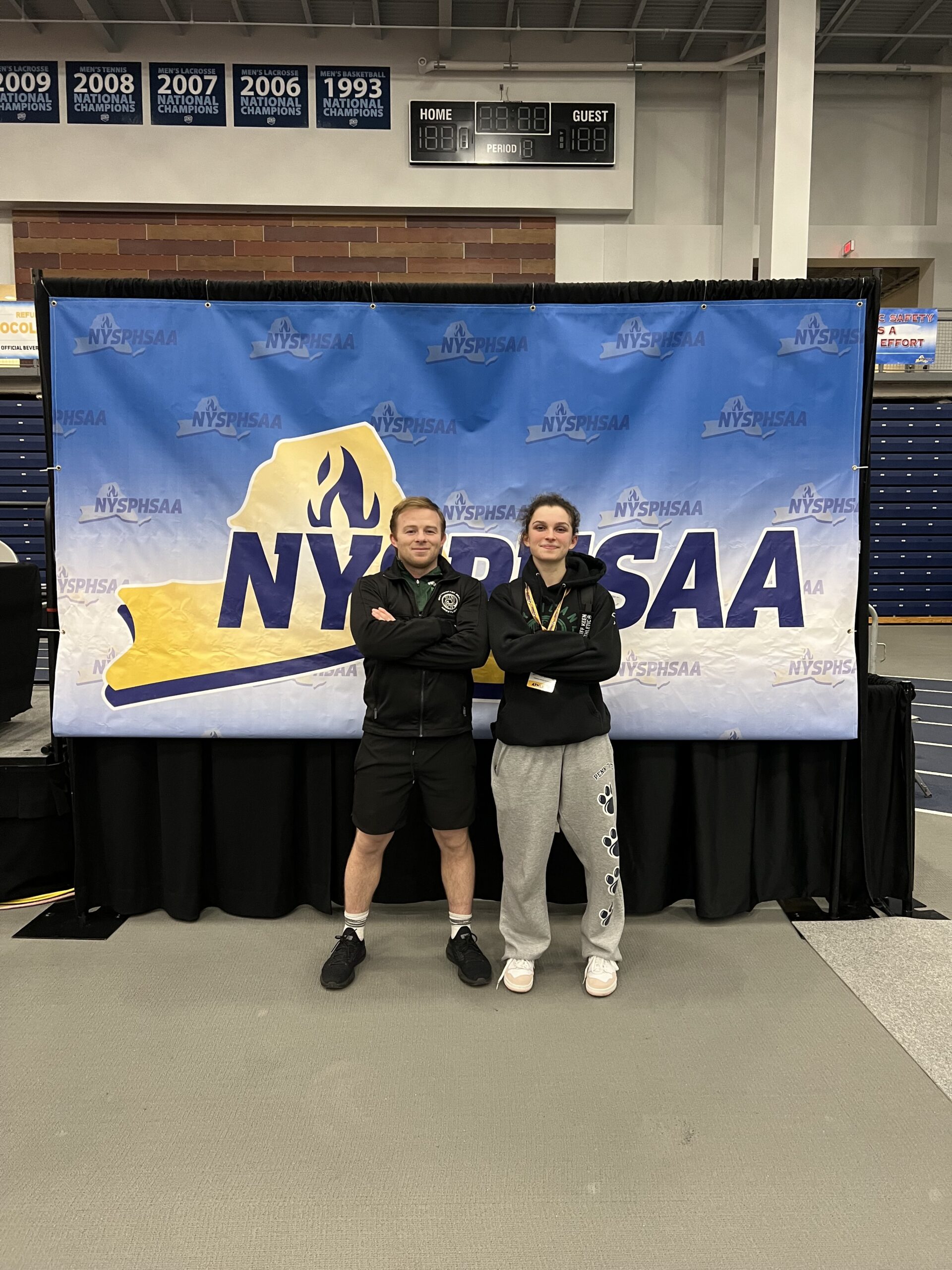 Juliet Barnabee with head coach Pete DeTore at the New York State Girls Wrestling Championships.