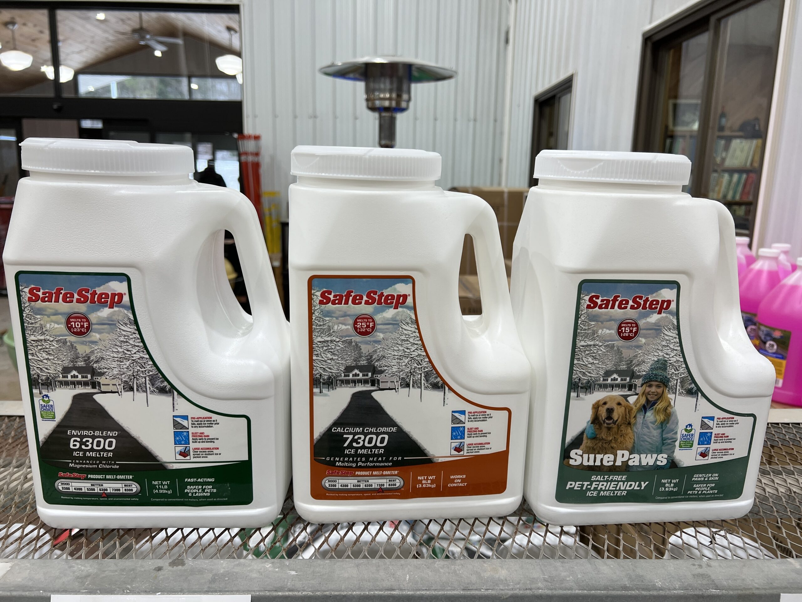 Jugs of ice melters are convenient, but their contents may be confusing. The SafeStep 6300 (left) and SurePaws (right) are both magnesium chloride. The difference?  The 6300 weighs 11 pounds while the SurePaws is only 8 pounds. Same exact stuff though. In the middle is the 7300, which is calcium chloride.
ANDREW MESSINGER