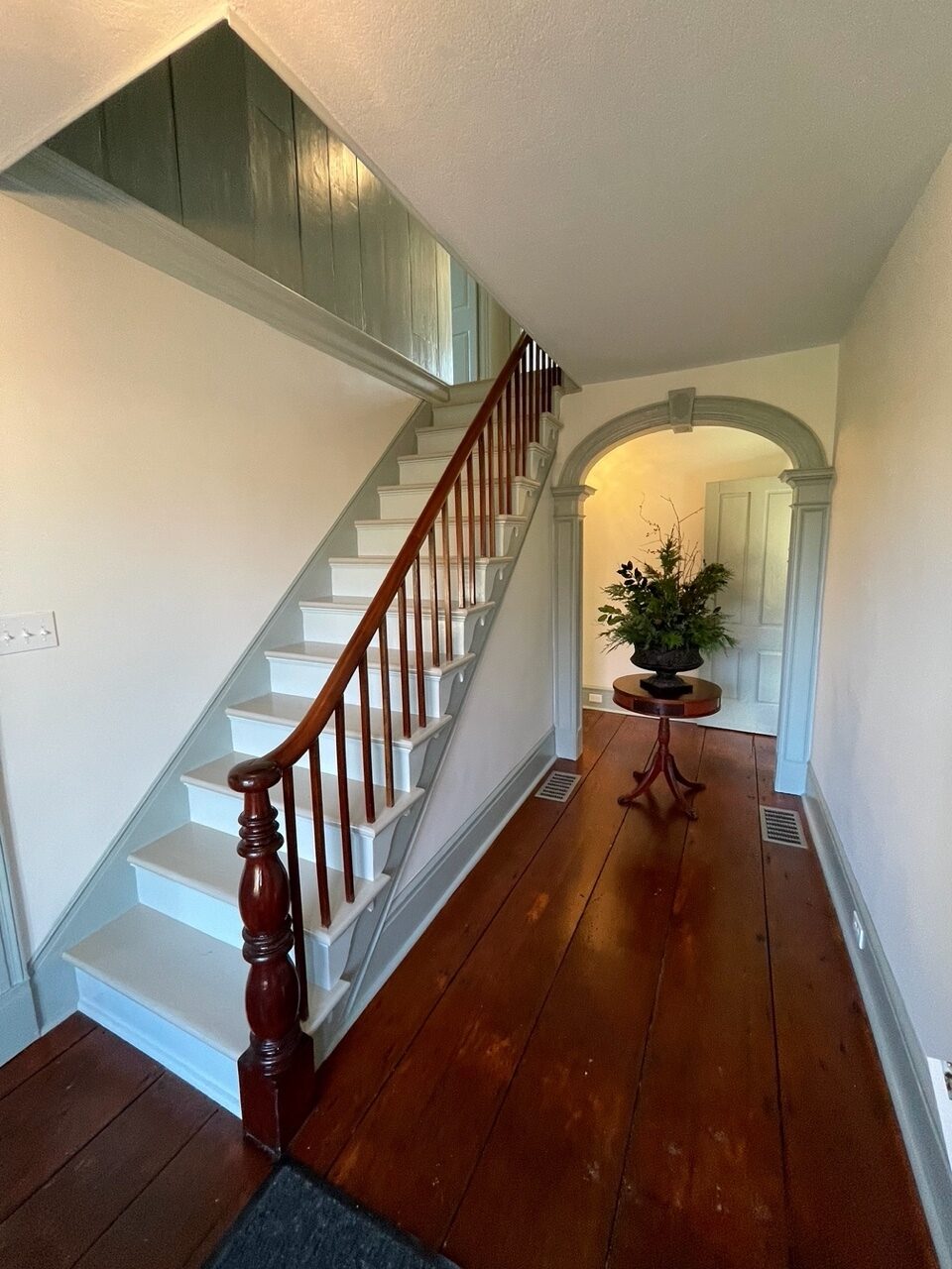 Center hall with wide-plank floors and original details on staircase and archway at rear in the Lt. Moses Case House.  ANNE SURCHIN