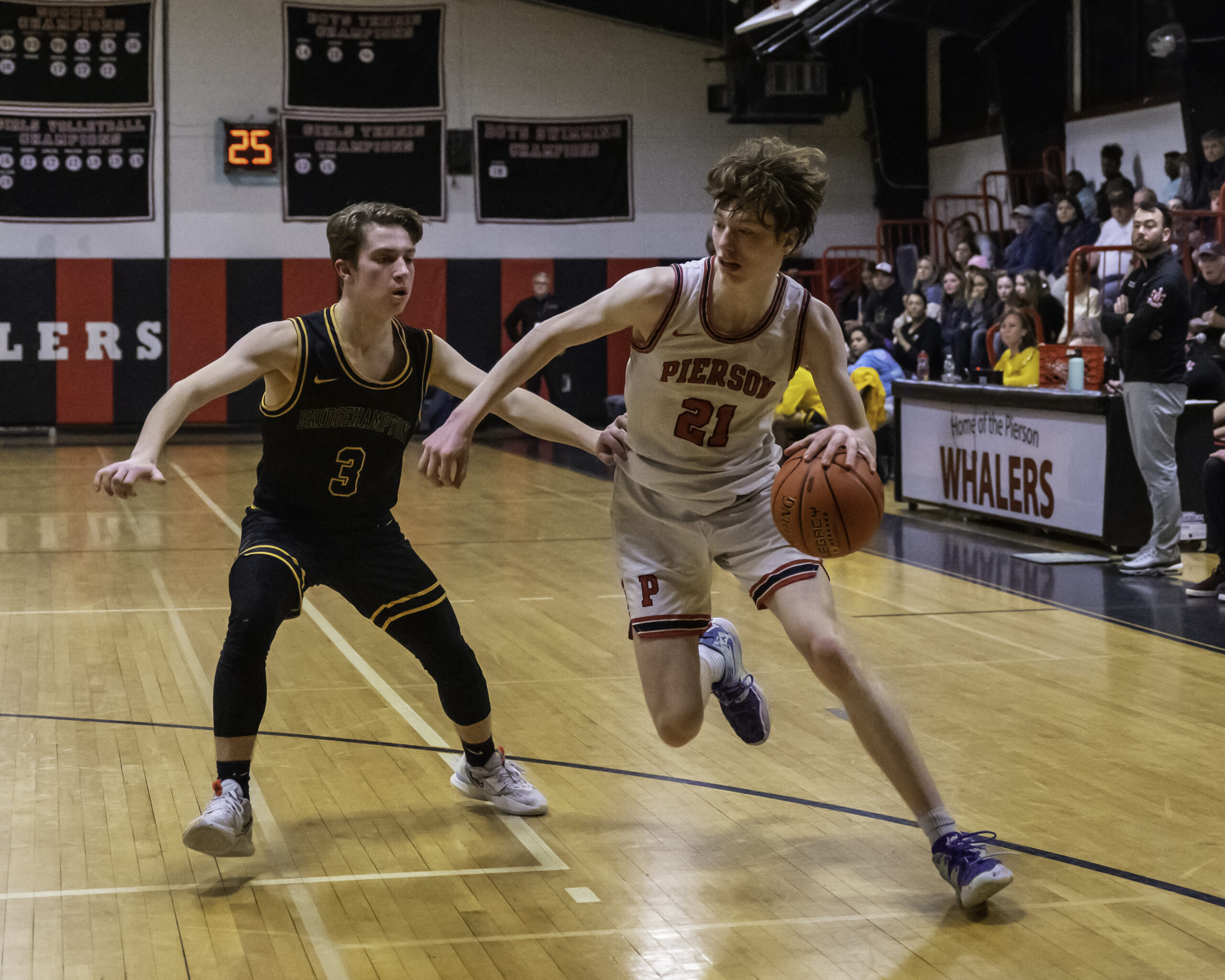 Whaler Luke Seltzer drives on Killer Bee Kris Vinski.   MARIANNE BARNETT
