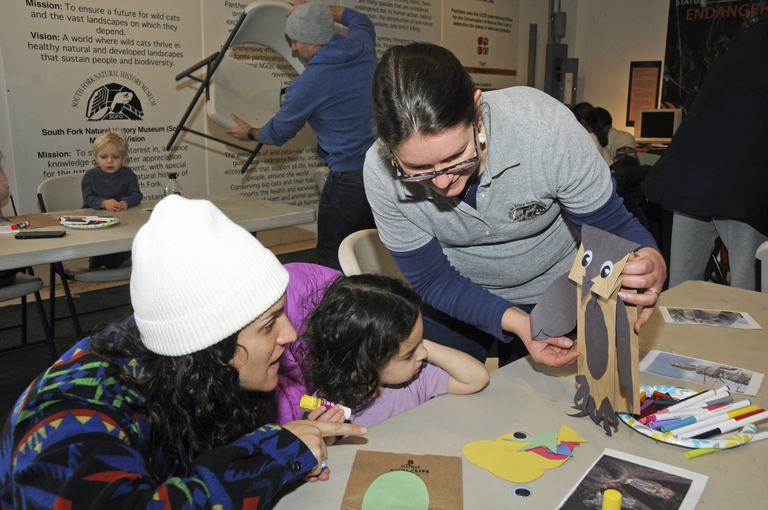 Blair and Charley Dver, along SoFo Membership Associate and Environmental Educator Crystal Possehl-Oakes work on an owl craft at the South Fork Natural History Museum in Bridgehampton on Sunday afternoon. Possehl-Oakes familiarized toddlers and parents with the lives of owls at 