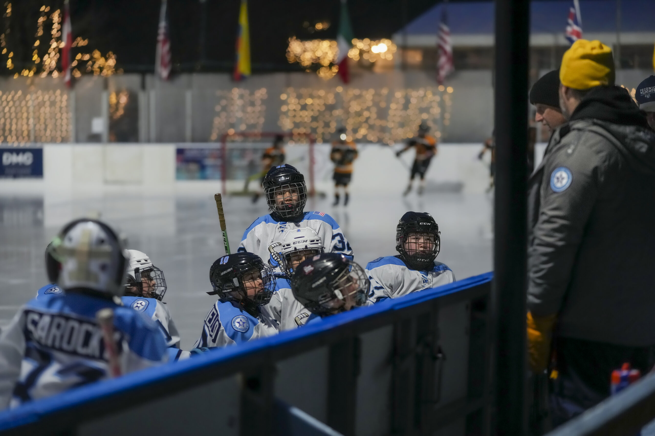 The Peconic Wildcats 10U team listens to their coaches from the ice during Saturday morning's game.    RON ESPOSITO