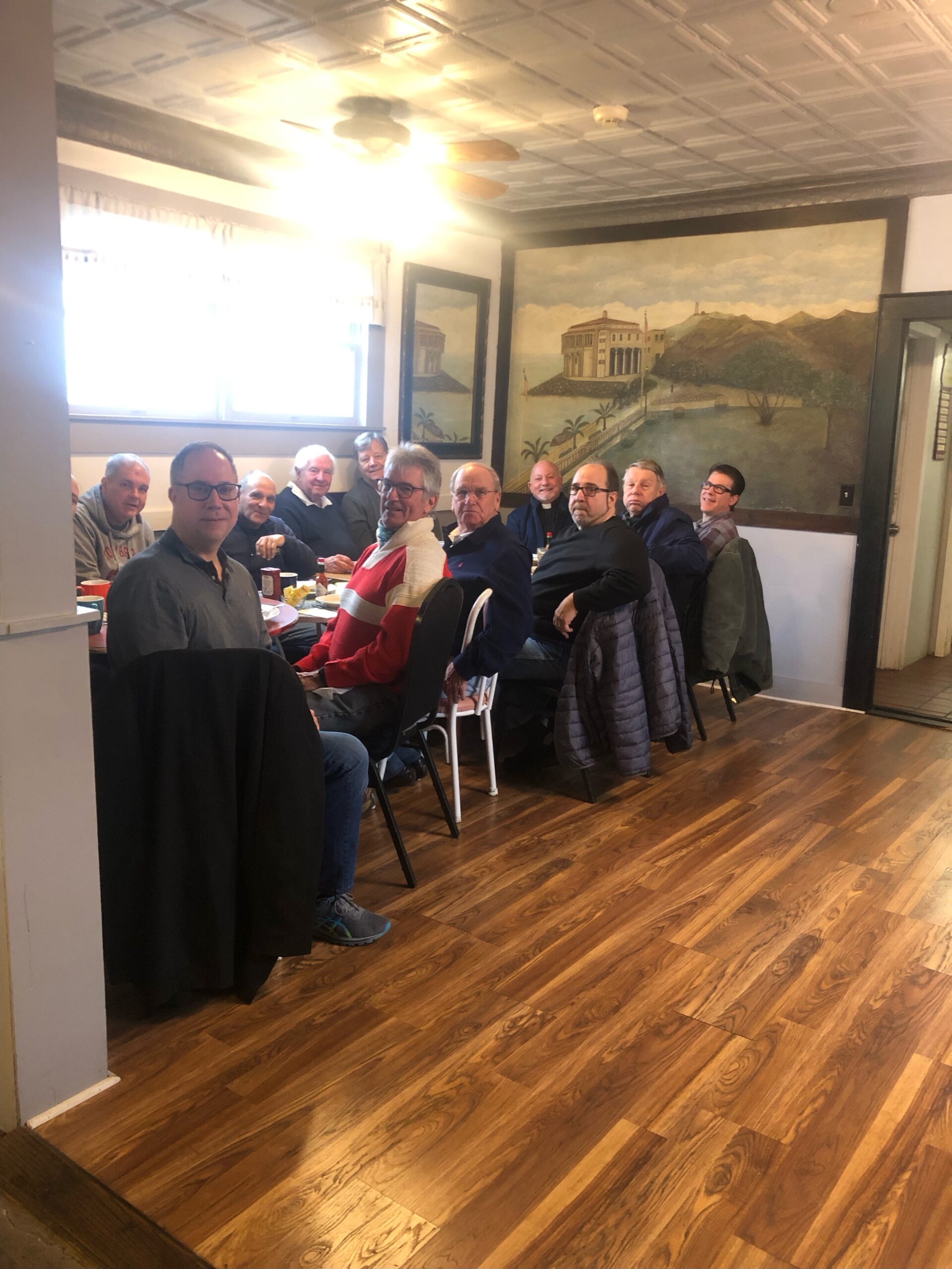 The Men's Breakfast Group at St. Mark's Church in Westhampton Beach recently gathered for one of its regular discussions with Father Chris Jubinski. COURTESY TOM HADLOCK