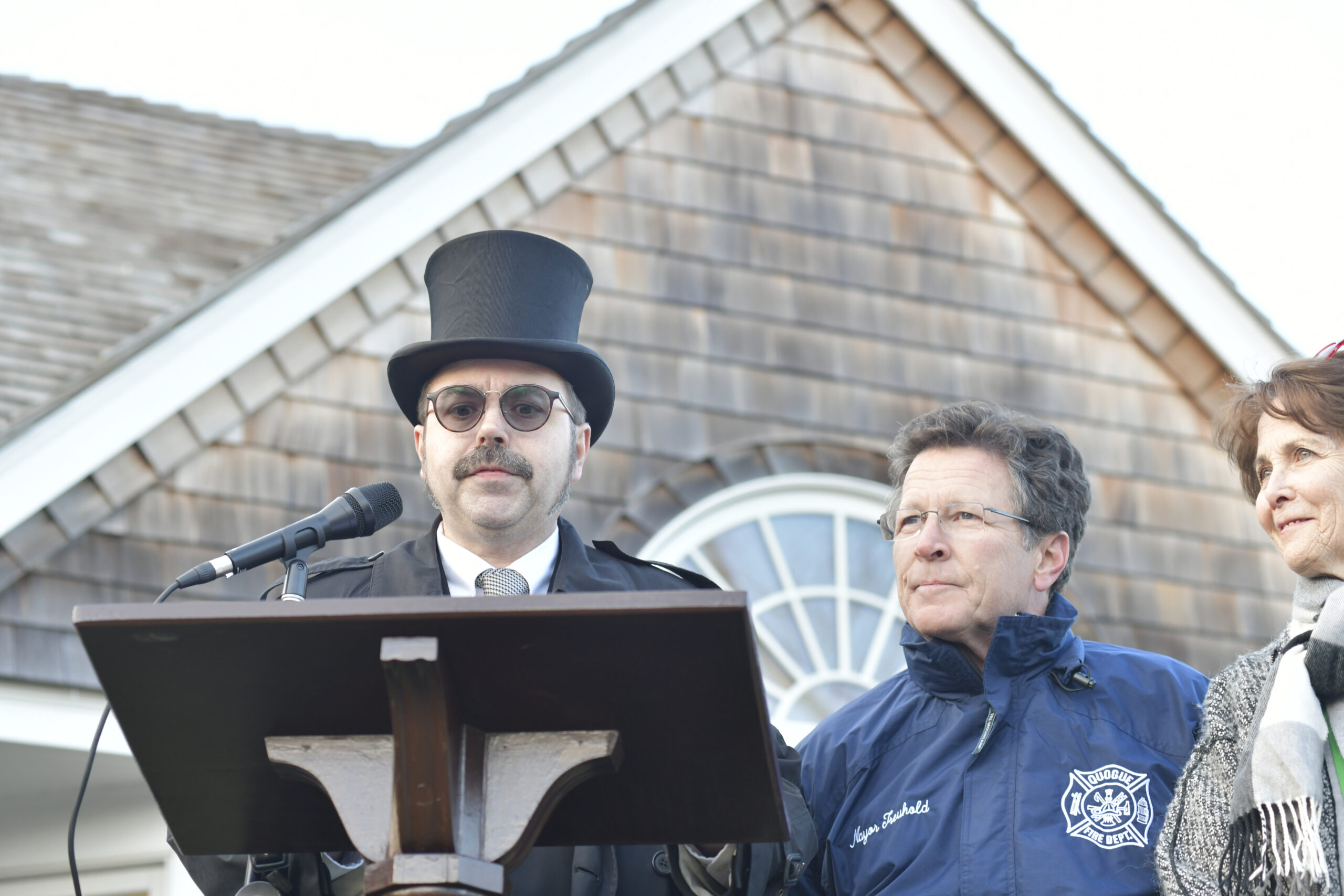 Master of Ceremonies Tim Walkman, with Quogue Village Mayor Robert Treuhold and Barbara Sartorious at the Groundhog Day festivities at the Quogue Library on Thursday afternoon.    DANA SHAW
