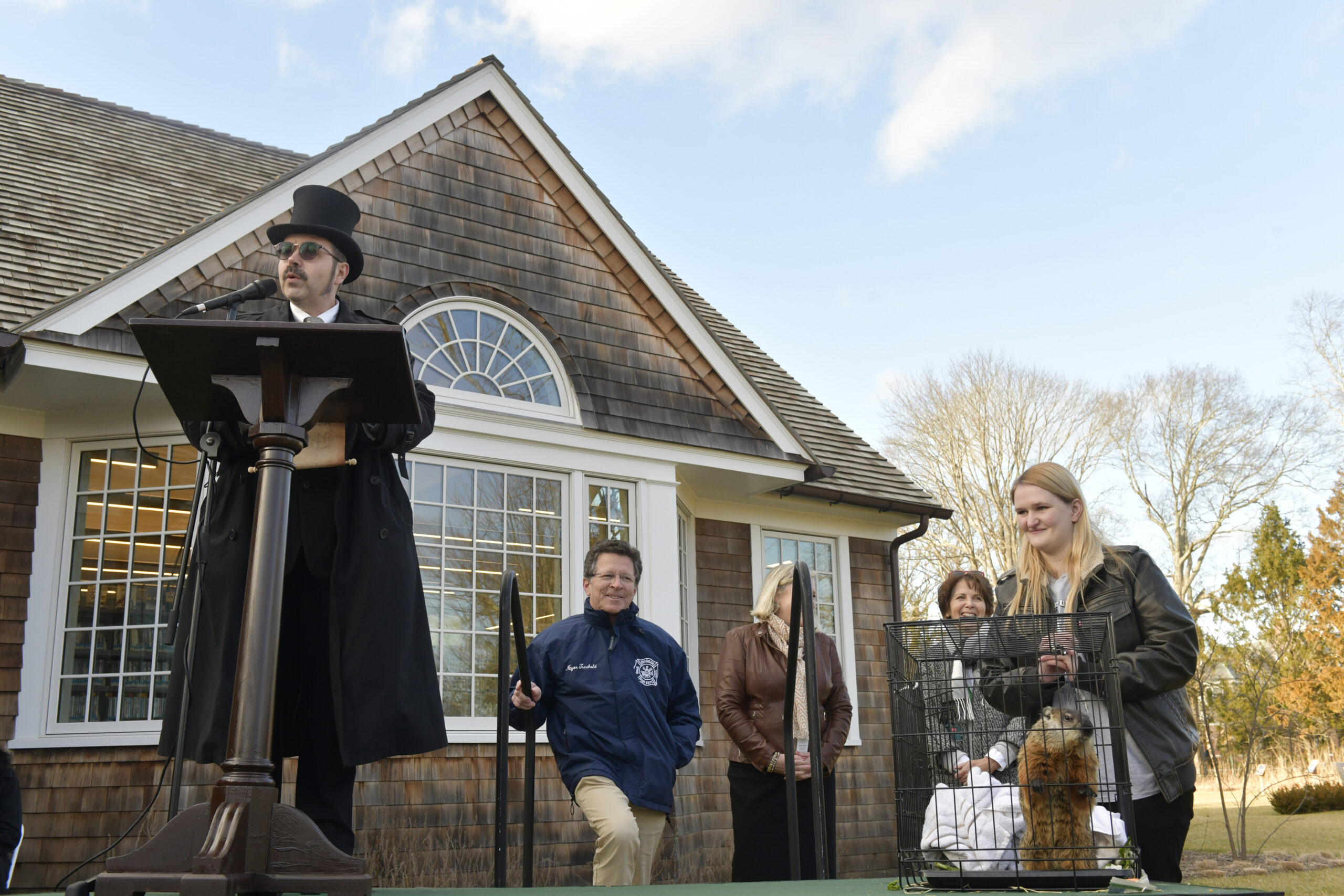 Master of Ceremonies Tim Walkman announces groundhog Sam Champions prediction at Groundhog Day festivities at the Quogue Library on Thursday afternoon. Sam predicted six more weeks of winter.   DANA SHAW