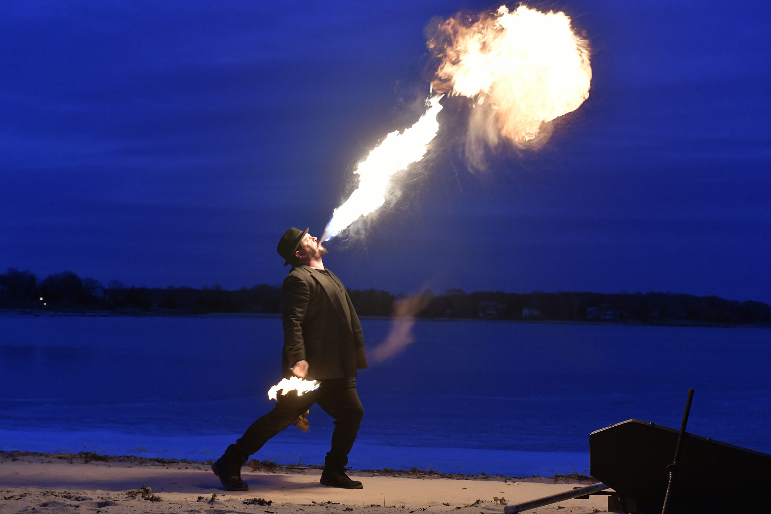 Rob Romeo spits fire during Fire Dancing by Keith Leaf and His Flaming Friends at Windmill Beach on Saturday evening.   DANA SHAW
