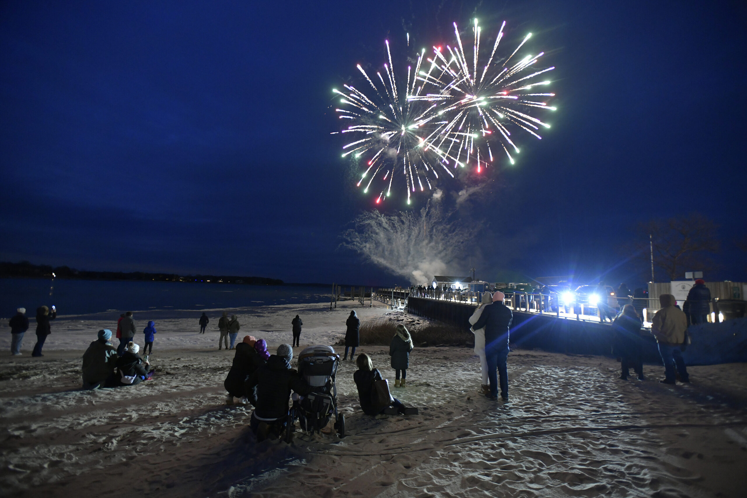 Folks braved the cold to watch fireworks by Grucci off Long Wharf.   DANA SHAW