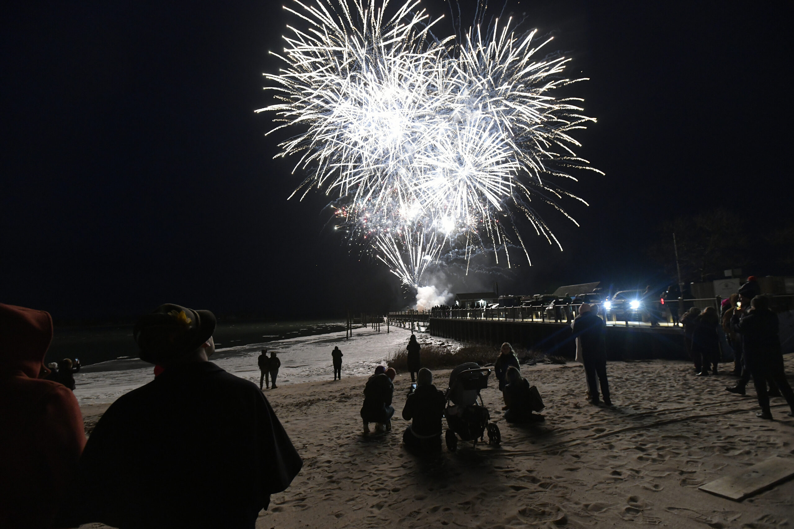 Folks braved the cold to watch fireworks by Grucci off Long Wharf.   DANA SHAW