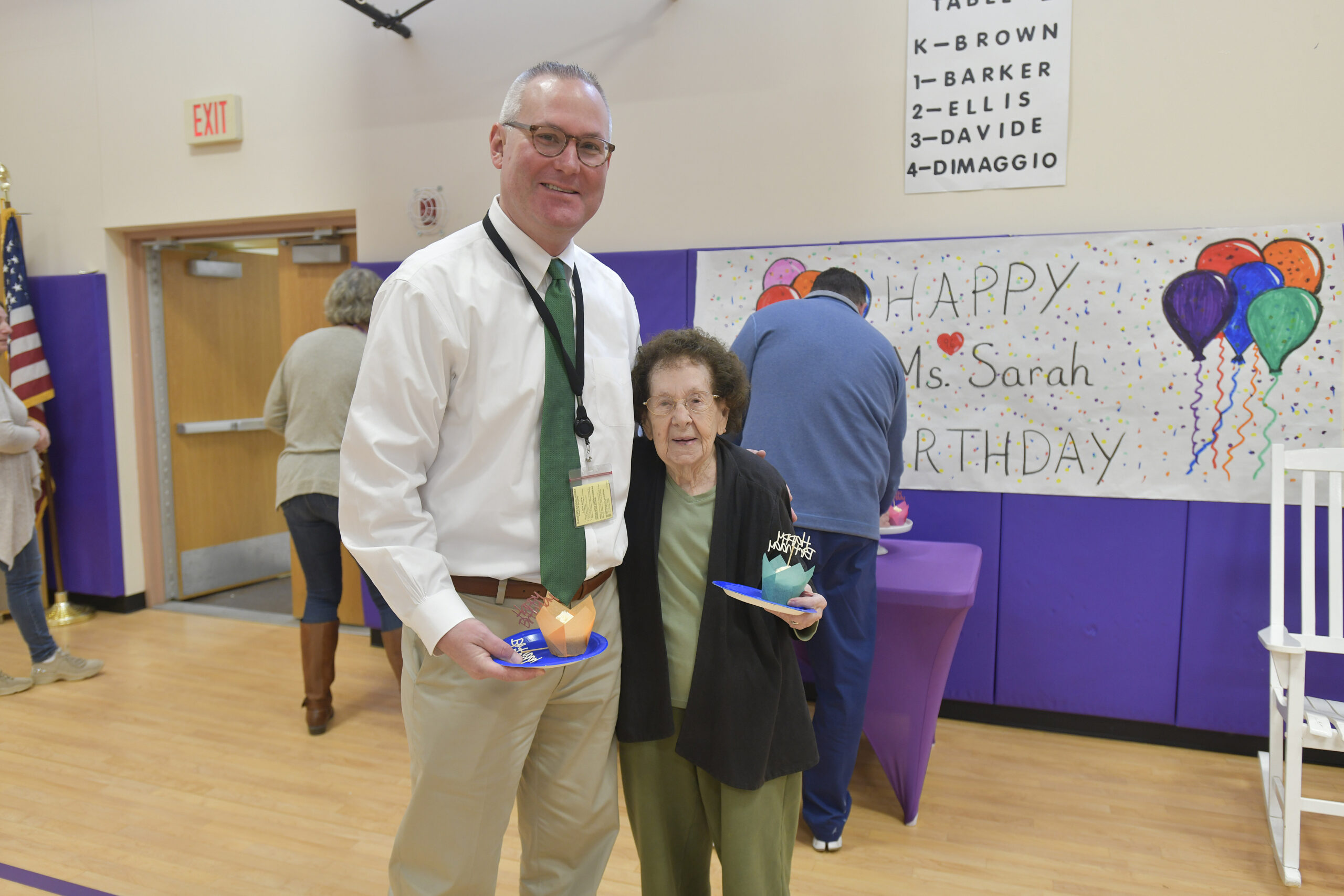 Hampton Bays Elementary teaching assistant Sarah Cunlifee with Superintendent Lars Clemensen, who she knew as a boy, at her 96th birthday celebration at Hampton Bays elementary School  on Tuesday morning.  DANA SHAW