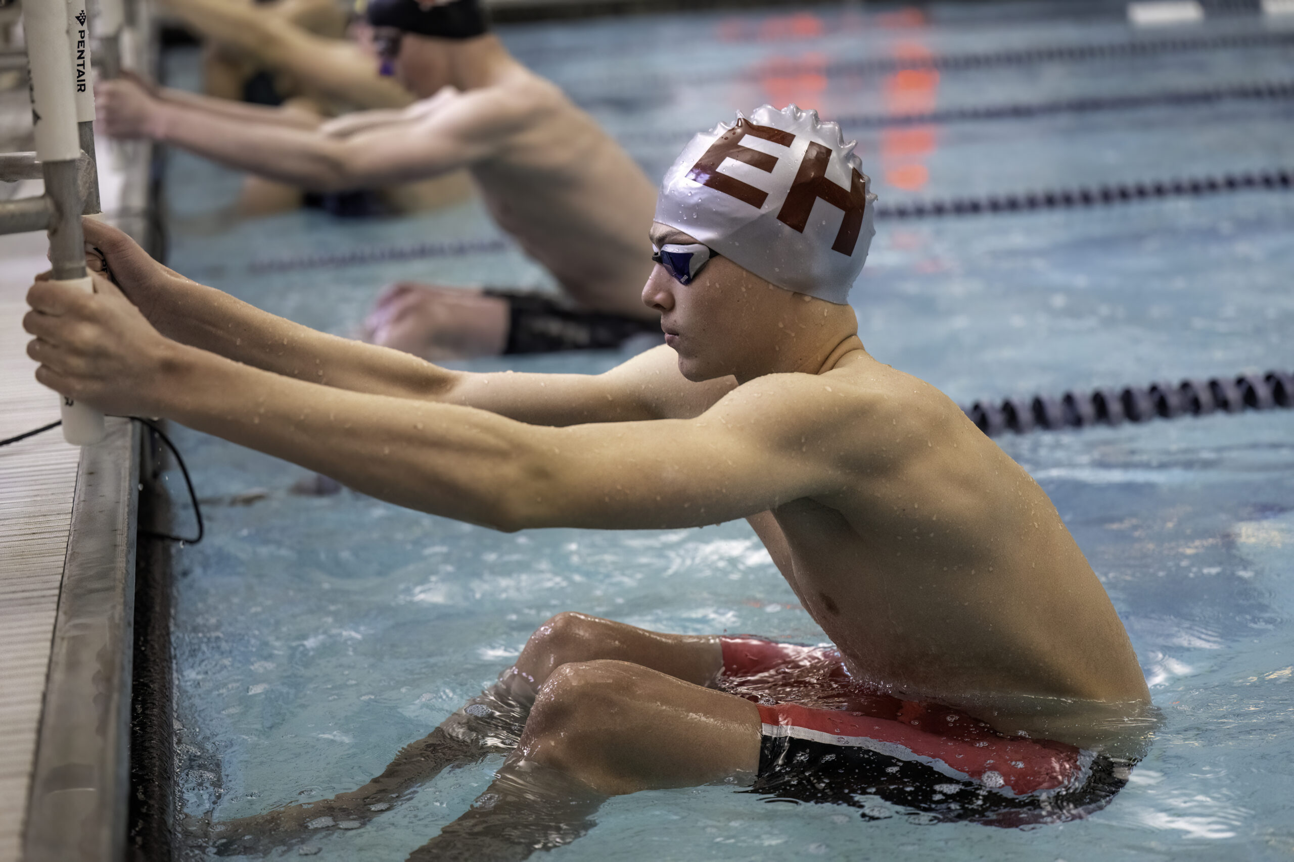 East Hampton's Liam Knight gets set to compete in the backstroke.  MARIANNE BARNETT
