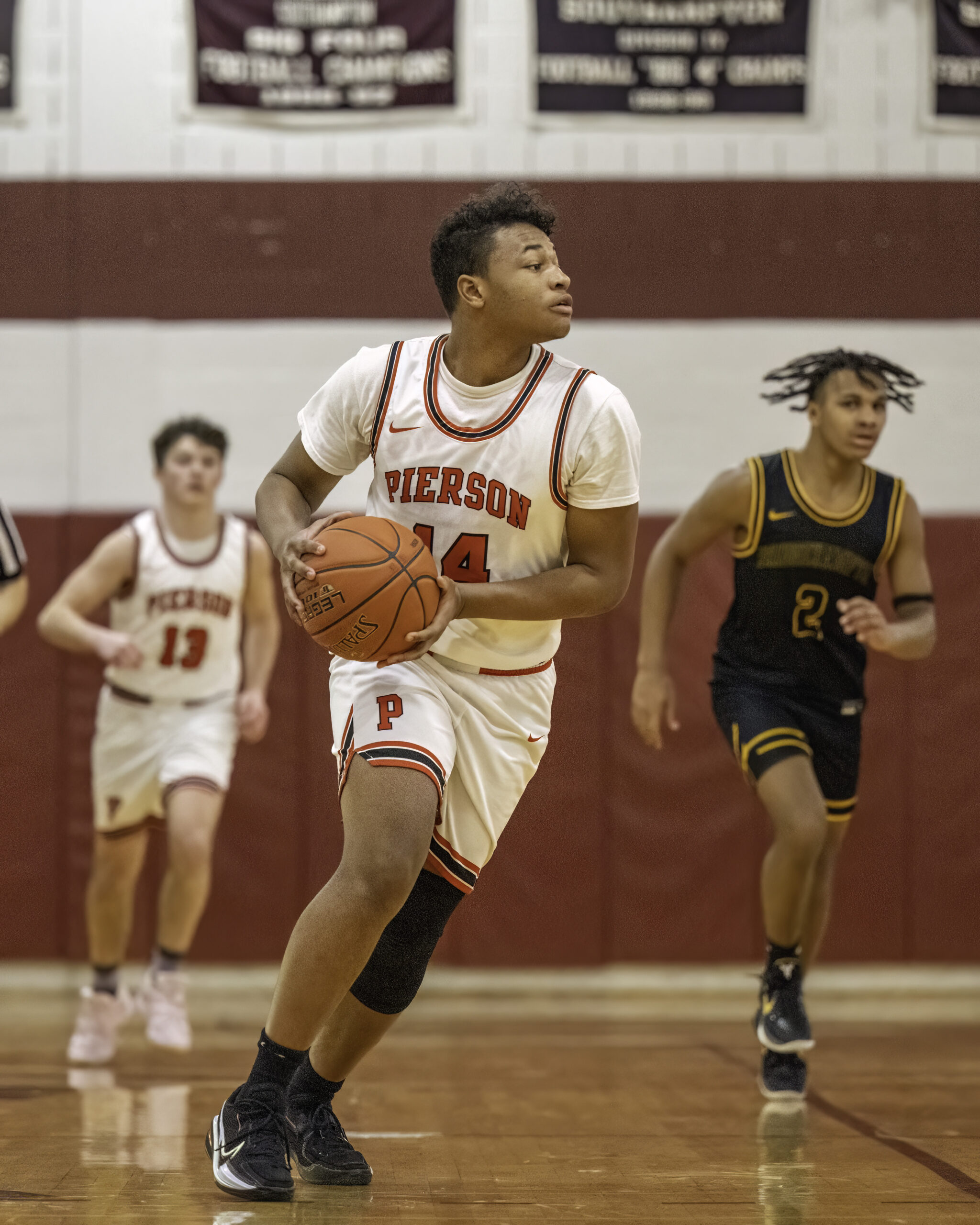 Pierson senior Fritz Desir looks for an open teammate down the court.   MARIANNE BARNETT