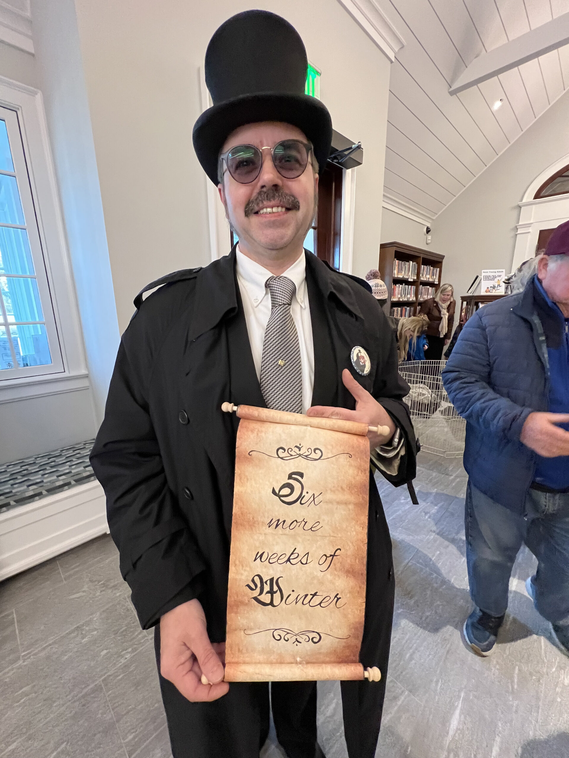 Master of Ceremonies Tim Walkman with Sam's prediction at the Groundhog Day festivities at the Quogue Library on Thursday afternoon.    DANA SHAW