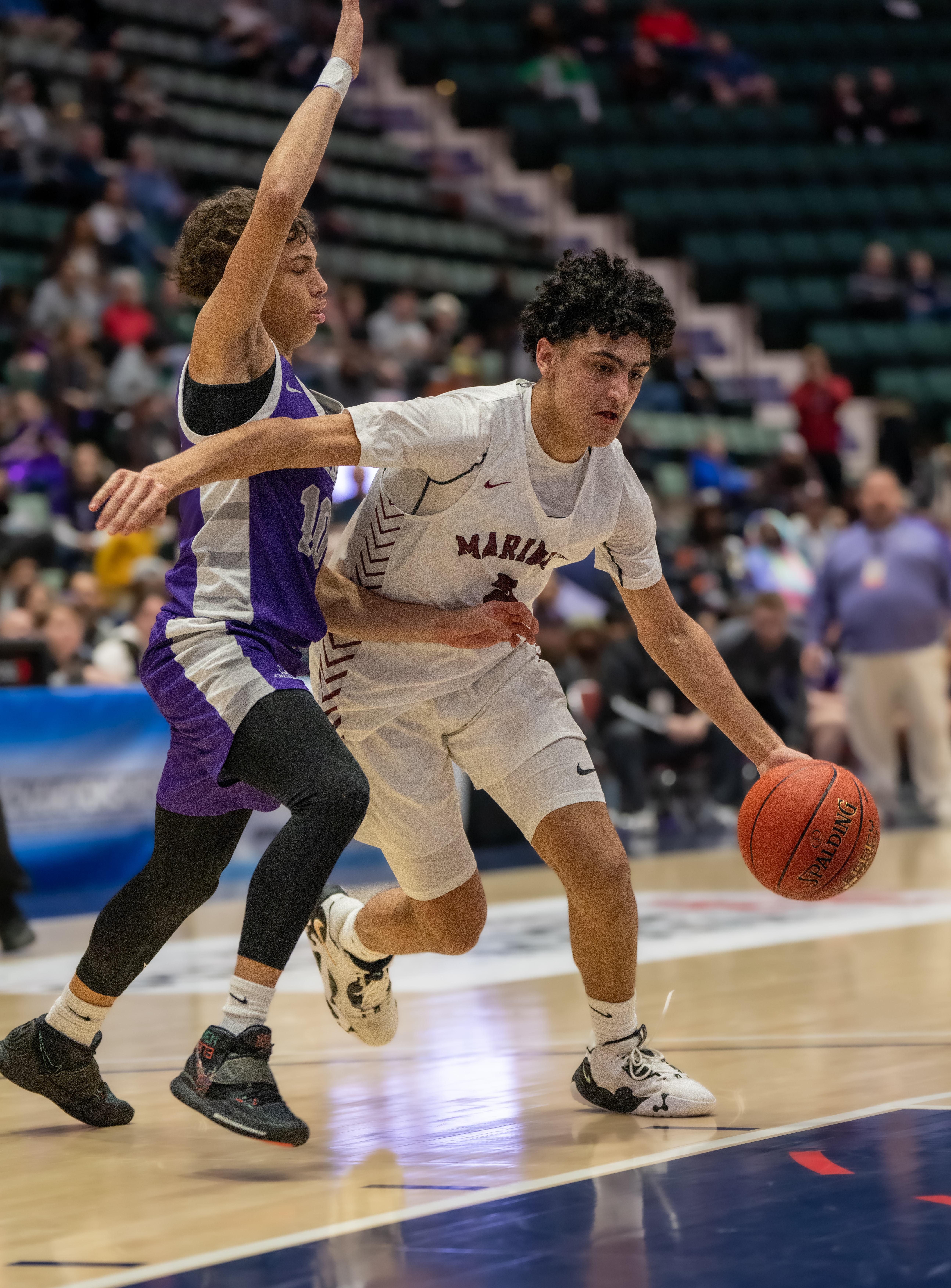 Mariner Alex Franklin looks to make a move around Crusader Xavyjon Arroyo.   RON ESPOSITO