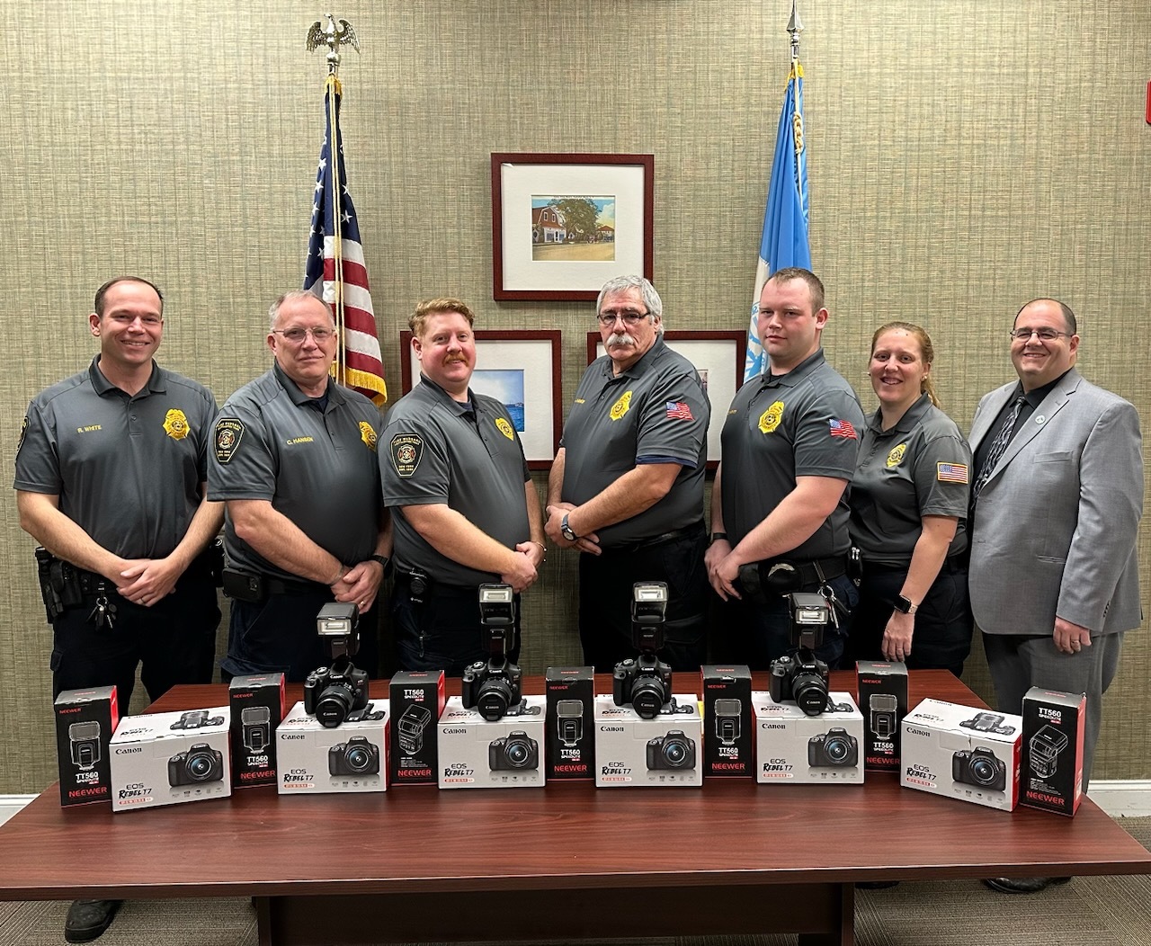 (L to R) Fire Marshal Ryan White, Senior Fire Marshal Chris Hansen, Fire Marshal Liam Keating, Chief Fire Marshal John Rankin, Fire Marshal Shane Sharkey, Fire Marshal Courtney Idtensohn, and Public Safety Administrator Ryan Murphy herald grant they used to purchase new camera kits for the fire marshals to utilize for documenting inspections and investigations.