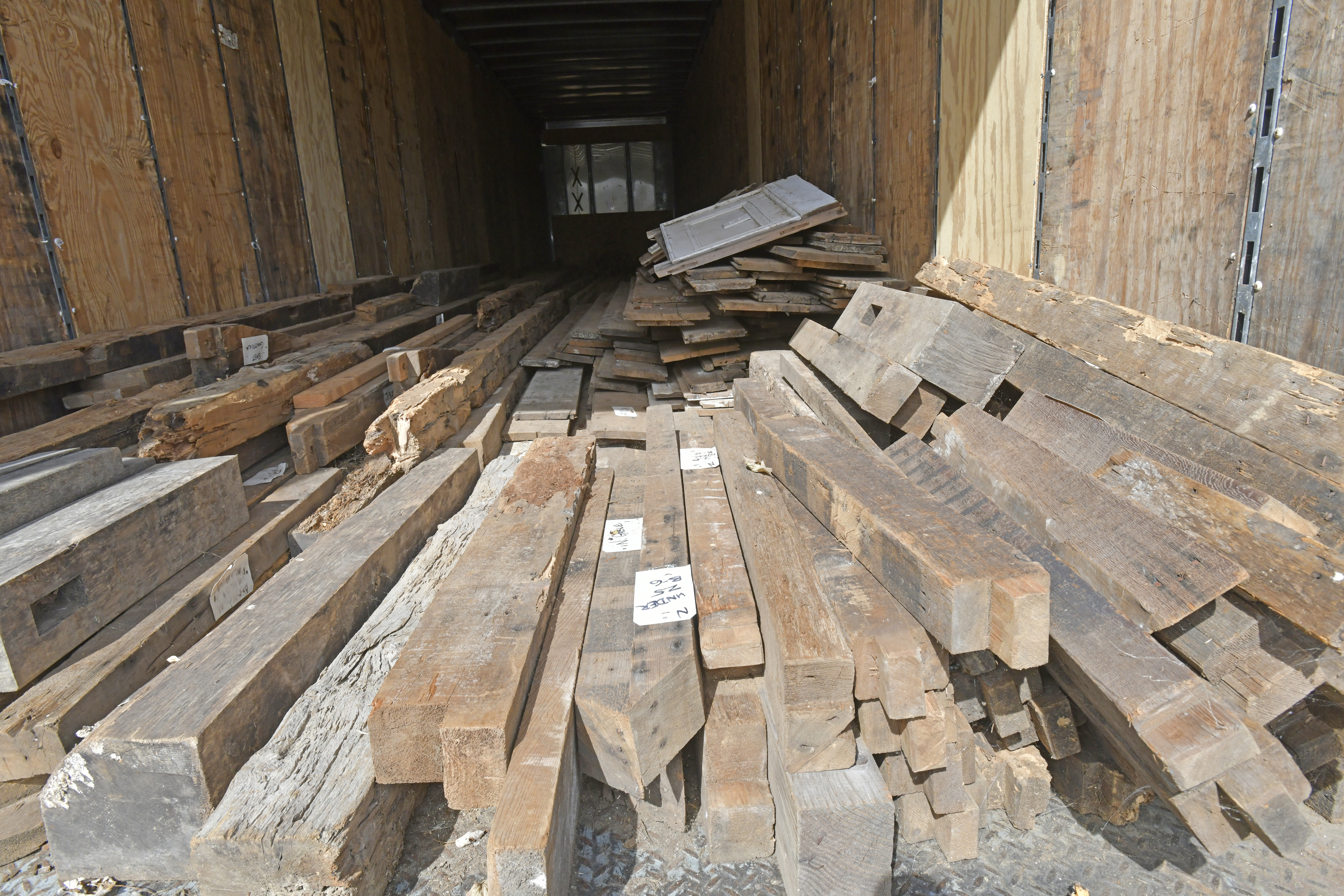 Timbers from the main house, which was torn down, are labeled and stored in a truck at the Concer Homestead.   DANA SHAW