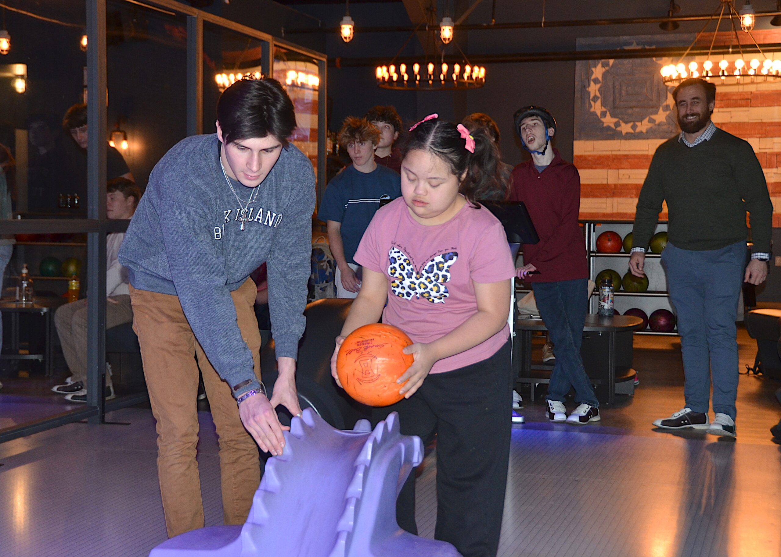 Cooper Ceva helps out Nicole Verdugo  bowling at The Clubhouse on Monday.   KYRIL BROMLEY