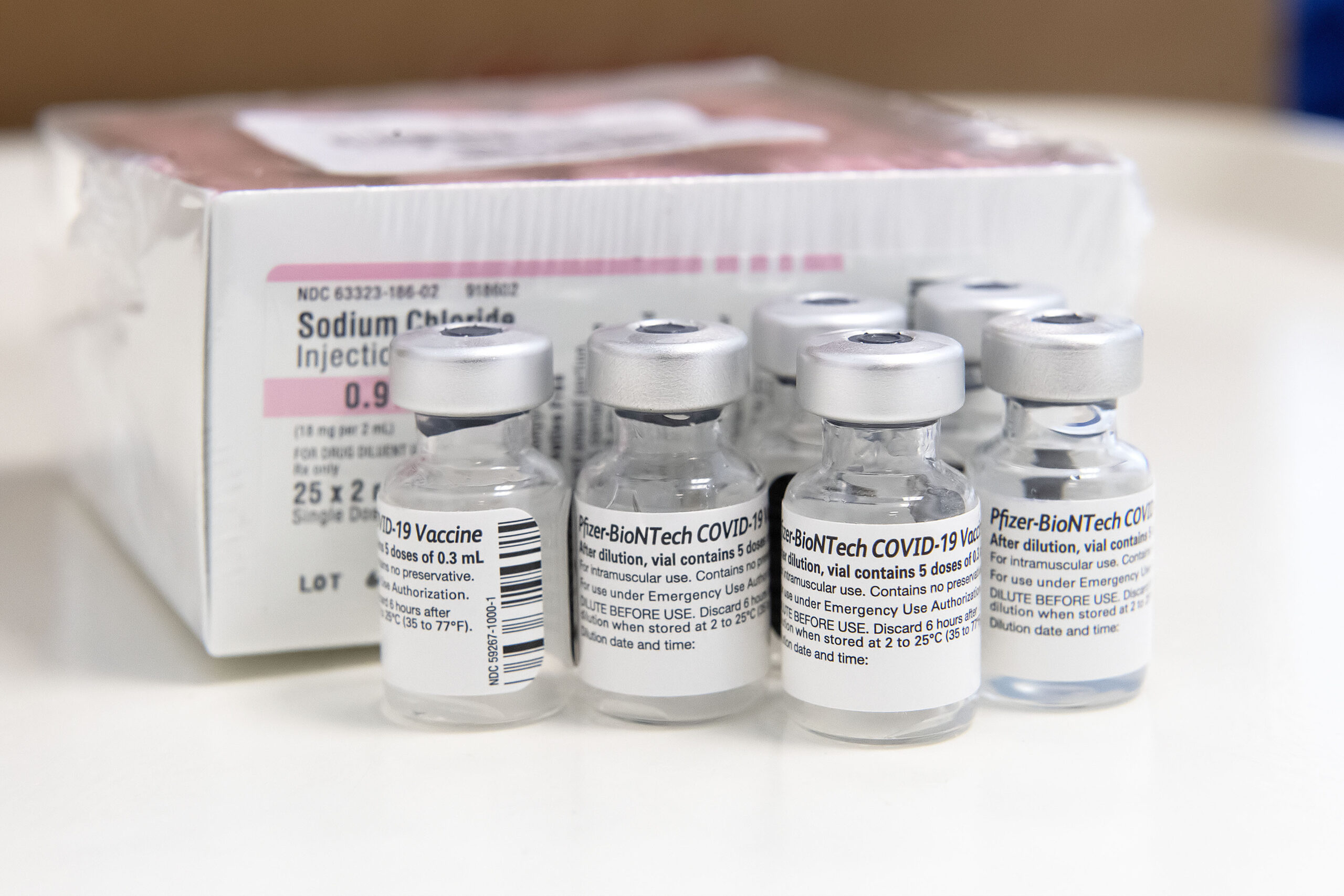 Used bottles of the Pfizer COVID-19 vaccine and their Sodium Chloride diffuser during a vaccination session held at the former Child Development Center of the Hamptons facility on Stephen Hands Path in East Hampton on February 13, 2021.     MICHAEL HELLER
