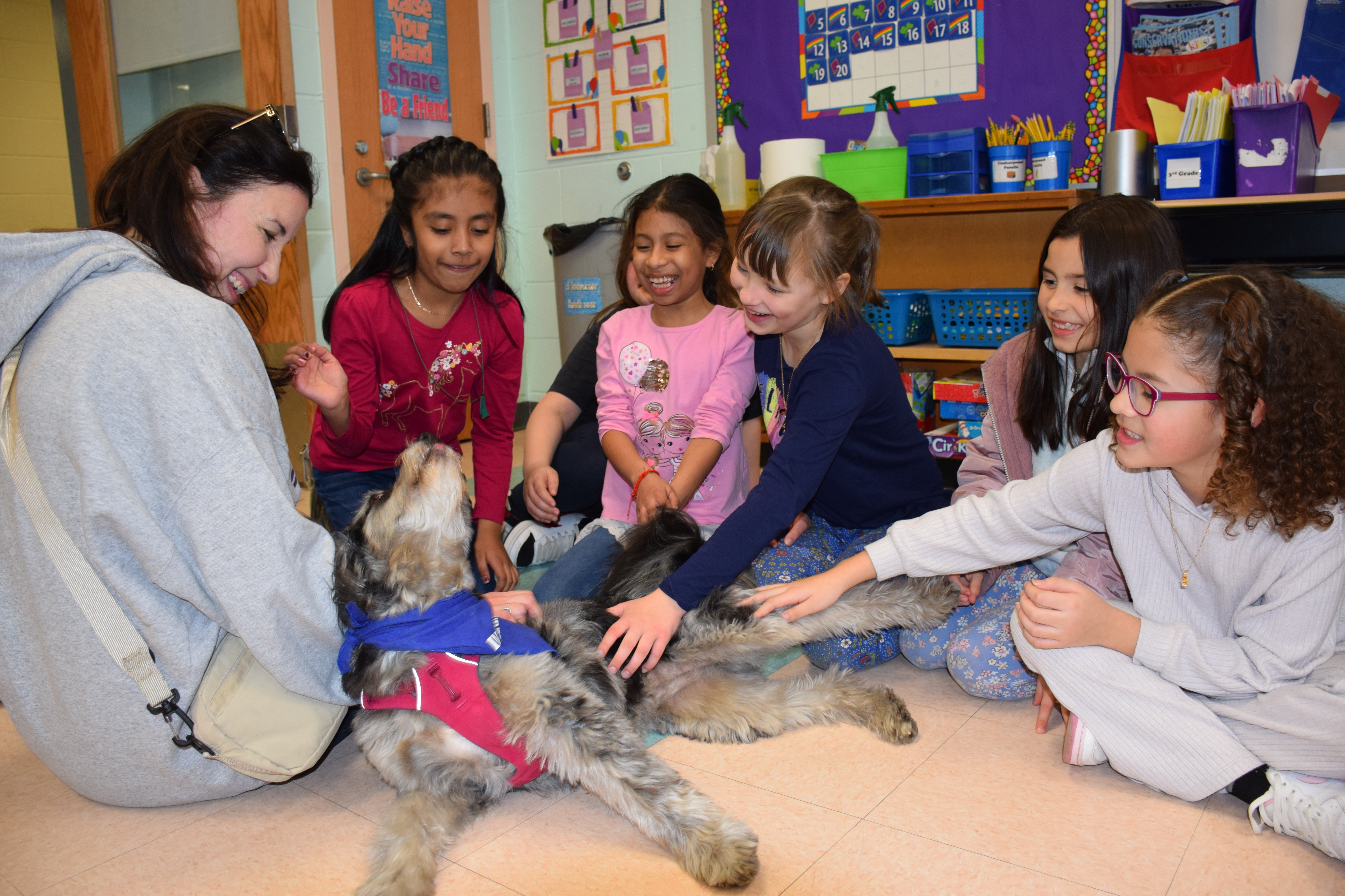 Nicole Neroulas’ students at Hampton Bays Elementary School recently spent time with her therapy dog, Luna. COURTESY HAMPTON BAYS SCHOOL DISTRICT