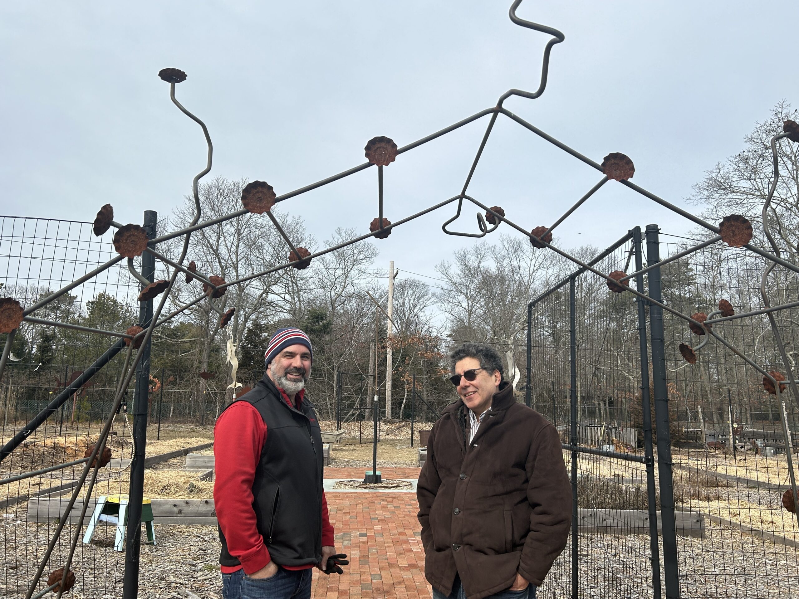 Tony Romano and Joe Lamport of Ecological Cultural Initiative at the entrance to the garden  and community compost project at St. Joseph Villas in Hampton Bays.    KITTY MERRILL