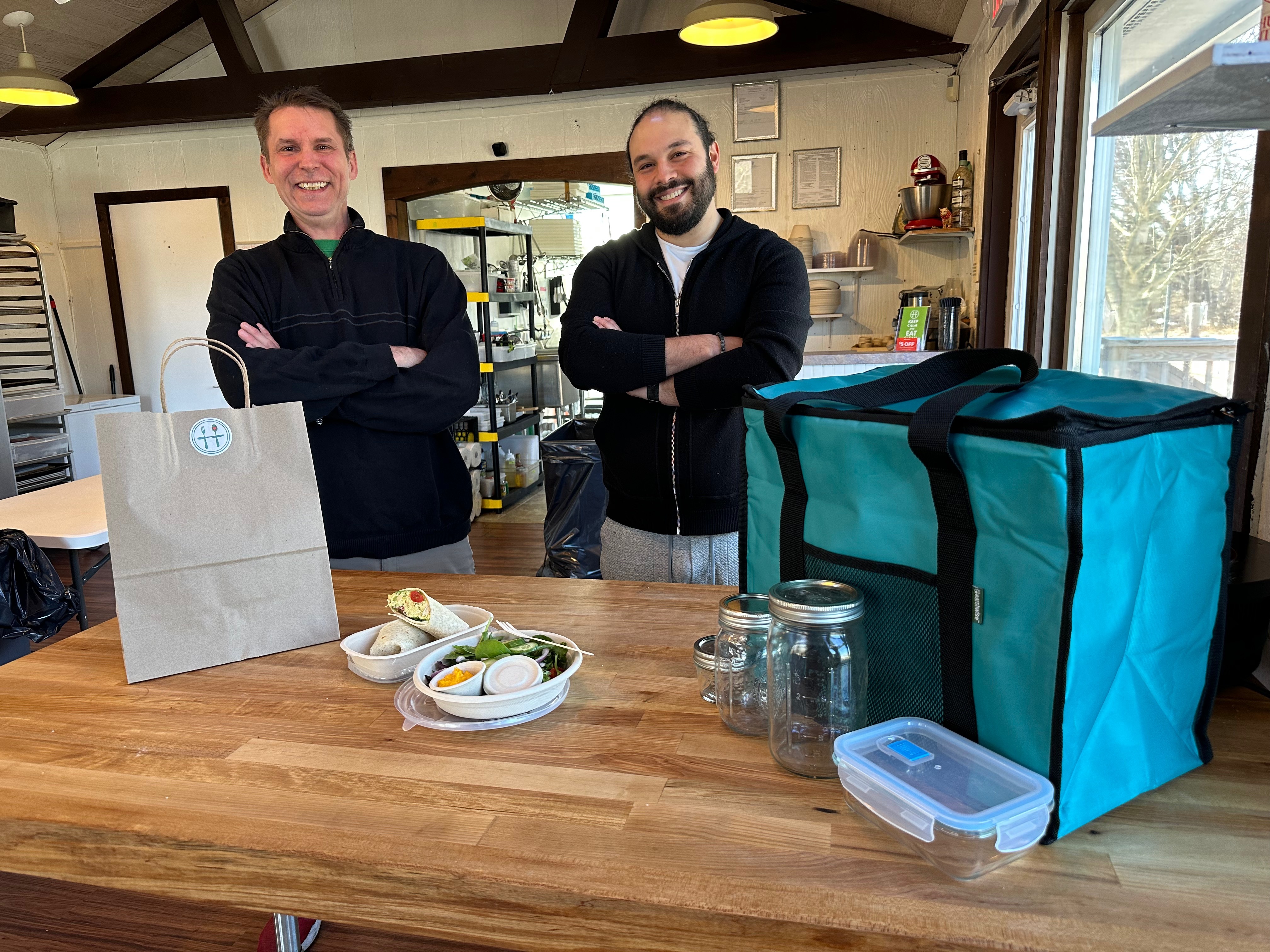 Chefs Jon Albrecht and Nick Reisini , co-owners of Honest Plate, in their Hampton Bays space with an order ready for delivery. ANNETTE HINKLE