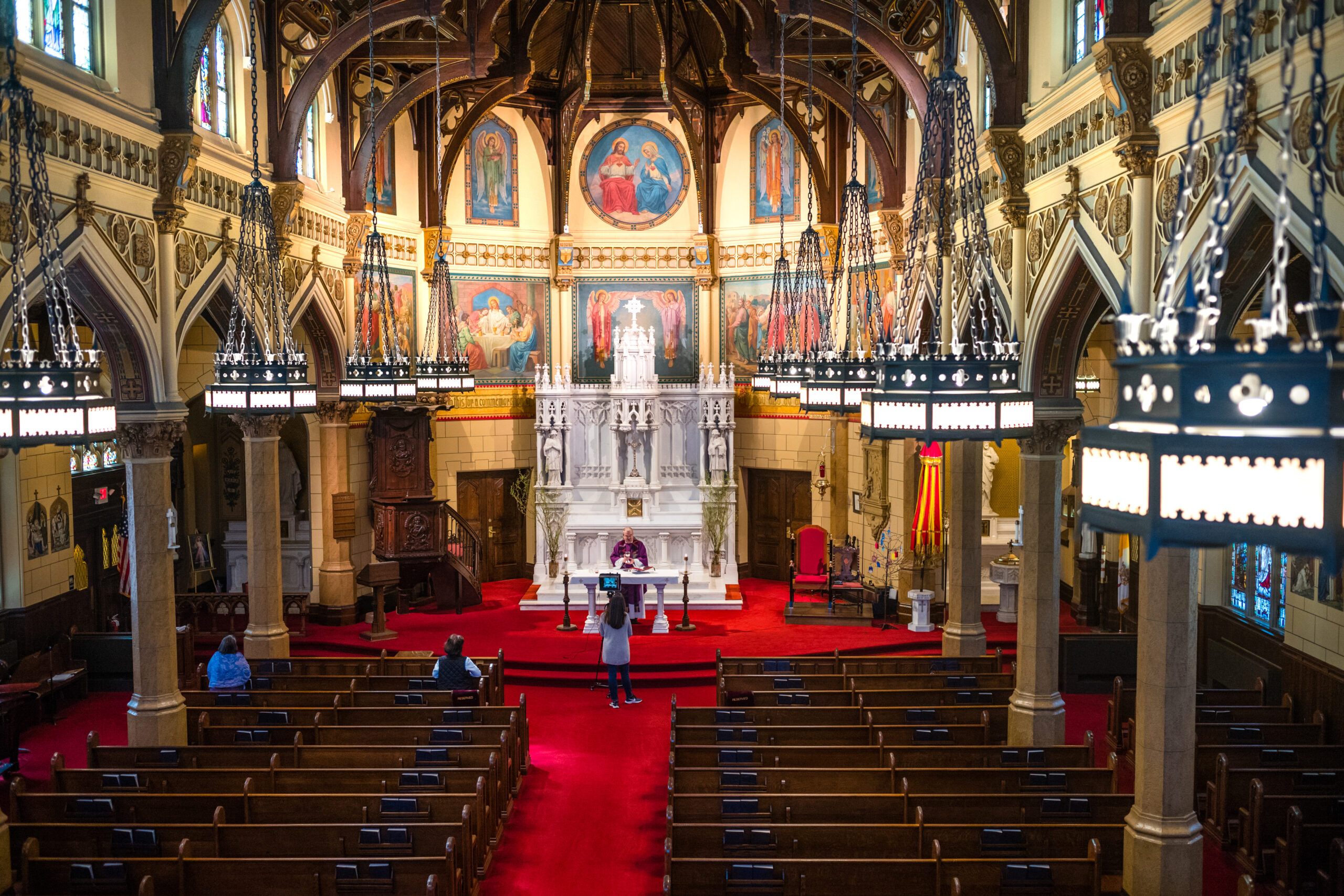 Father Michael A. Vetrano gives a mass during holy week by streaming in the empty basilica of the Sacred Hearts of Jesus and Mary on April 6, 2020 in Southampton.   LORI HAWKINS
