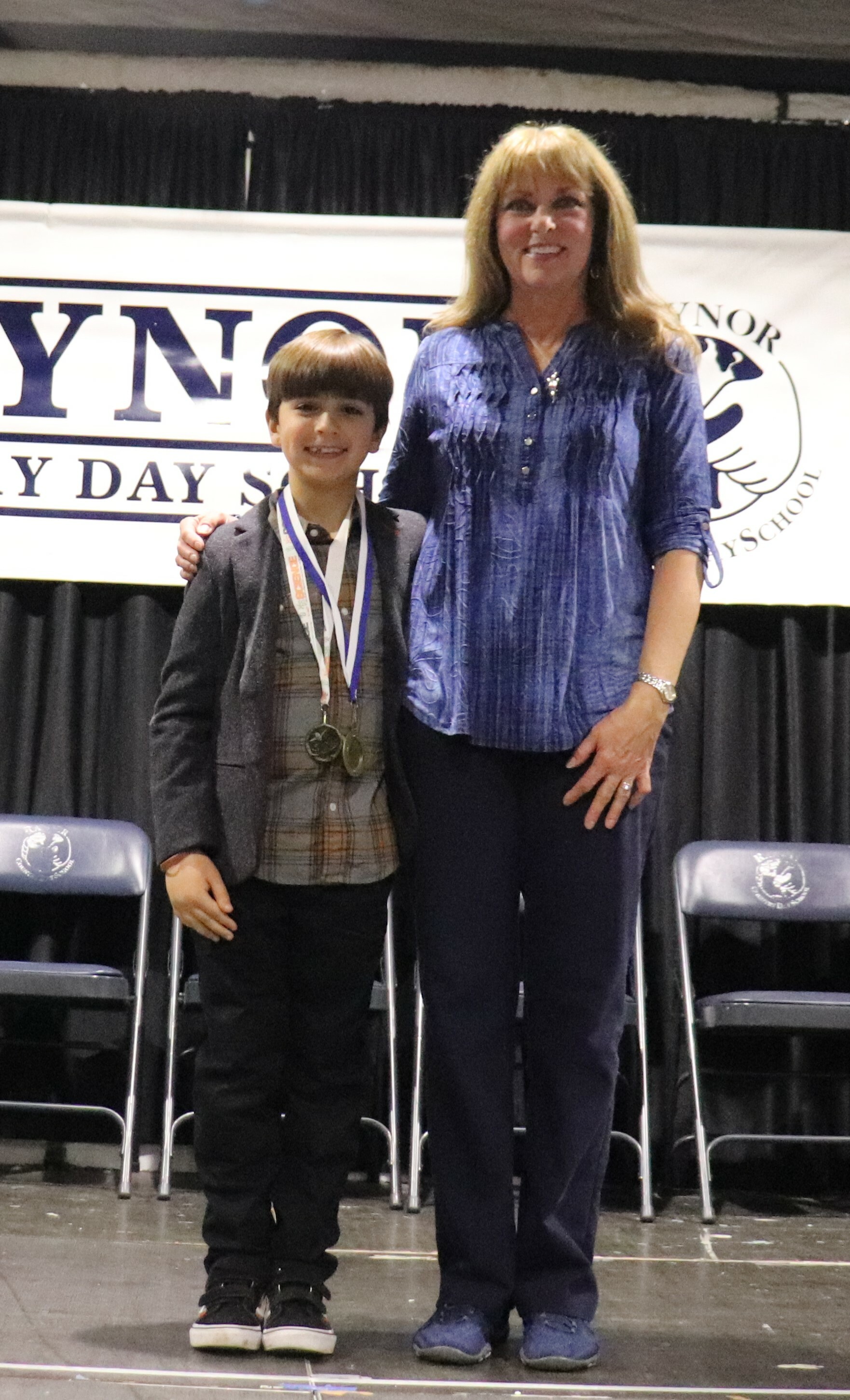 Raynor Country Day School Science Fair coordinator Elaine Marshall with third-grader Levi Beaver after he wone Best-In-Fair for his entry, The Science of Sticks in the competition. COURTESY RAYNOR COUNTRY DAY SCHOOL
