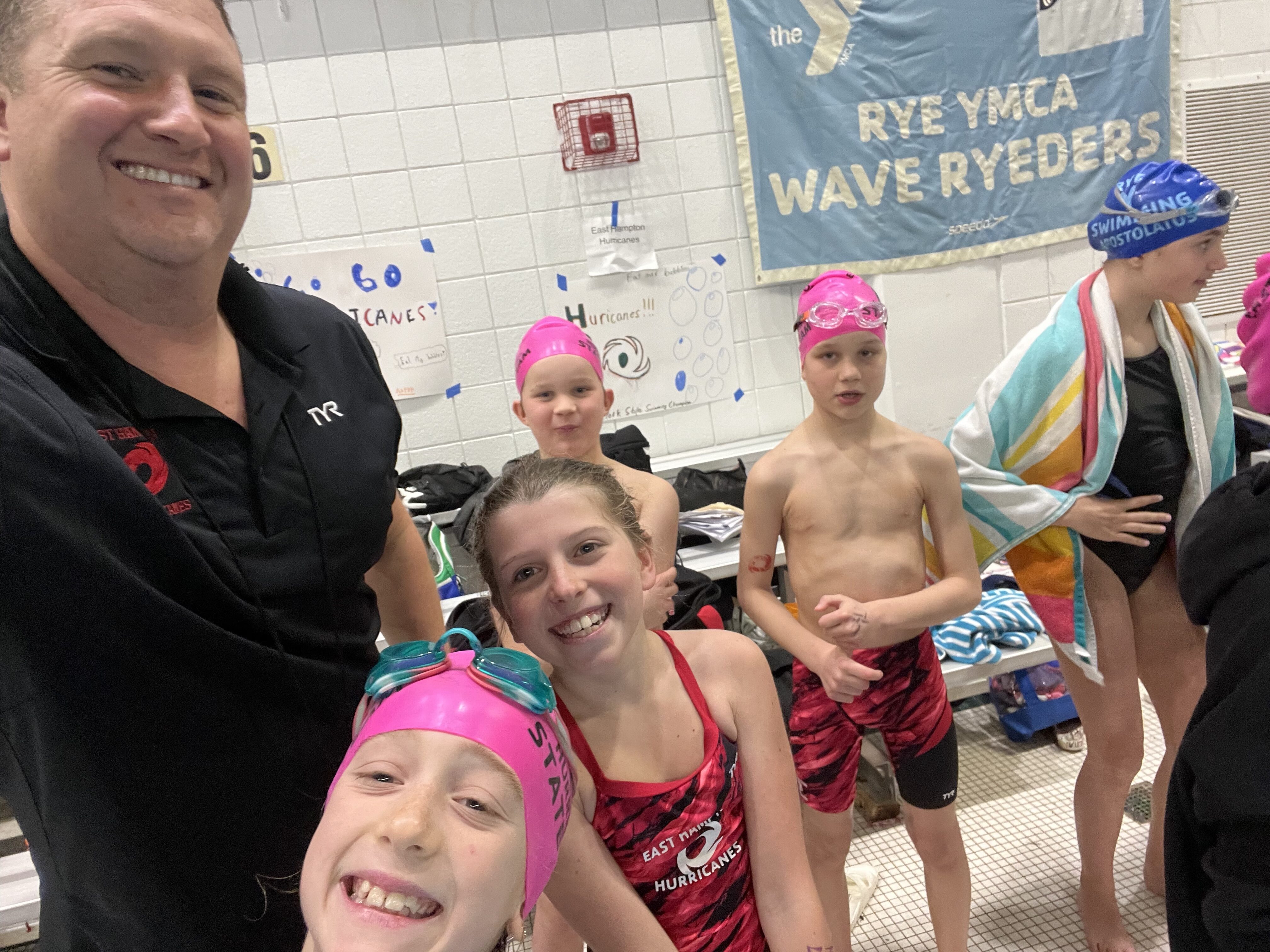 Hurricanes assistant coach Sean Knight with his young swimmers.