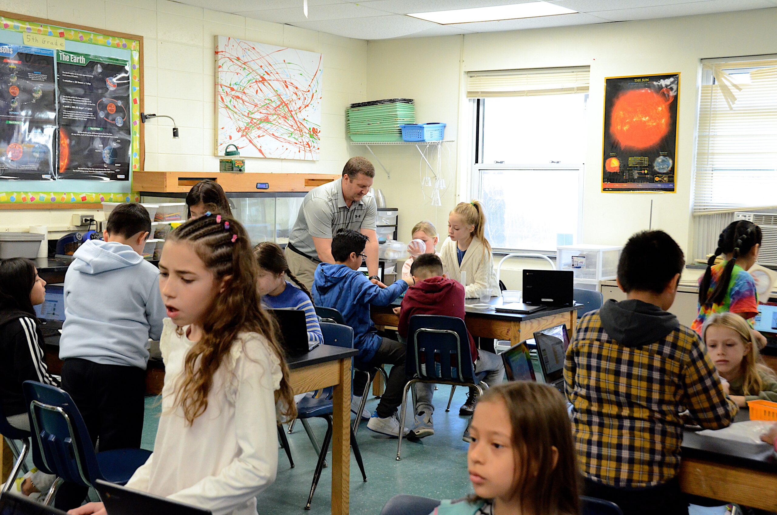 Springs School elementary science teacher Sean Knight works with students on an assignment. KYRIL BROMLEY