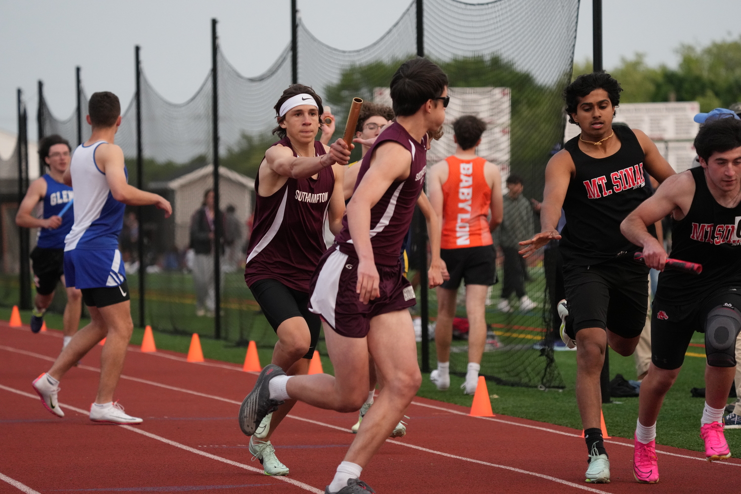 Southampton's Tanner Morro hands off to   in the 4x100-meter relay.   RON ESPOSITO