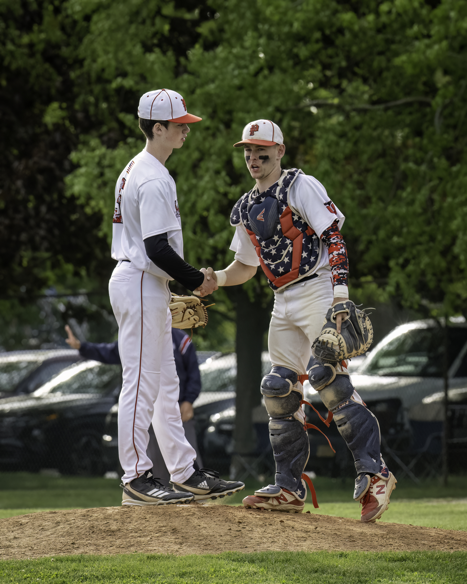 Catcher Gavin Gilbride gives a reaffirming handshake to his pitcher Nathan Dee who pitched well in relief on Friday.   MARIANNE BARNETT
