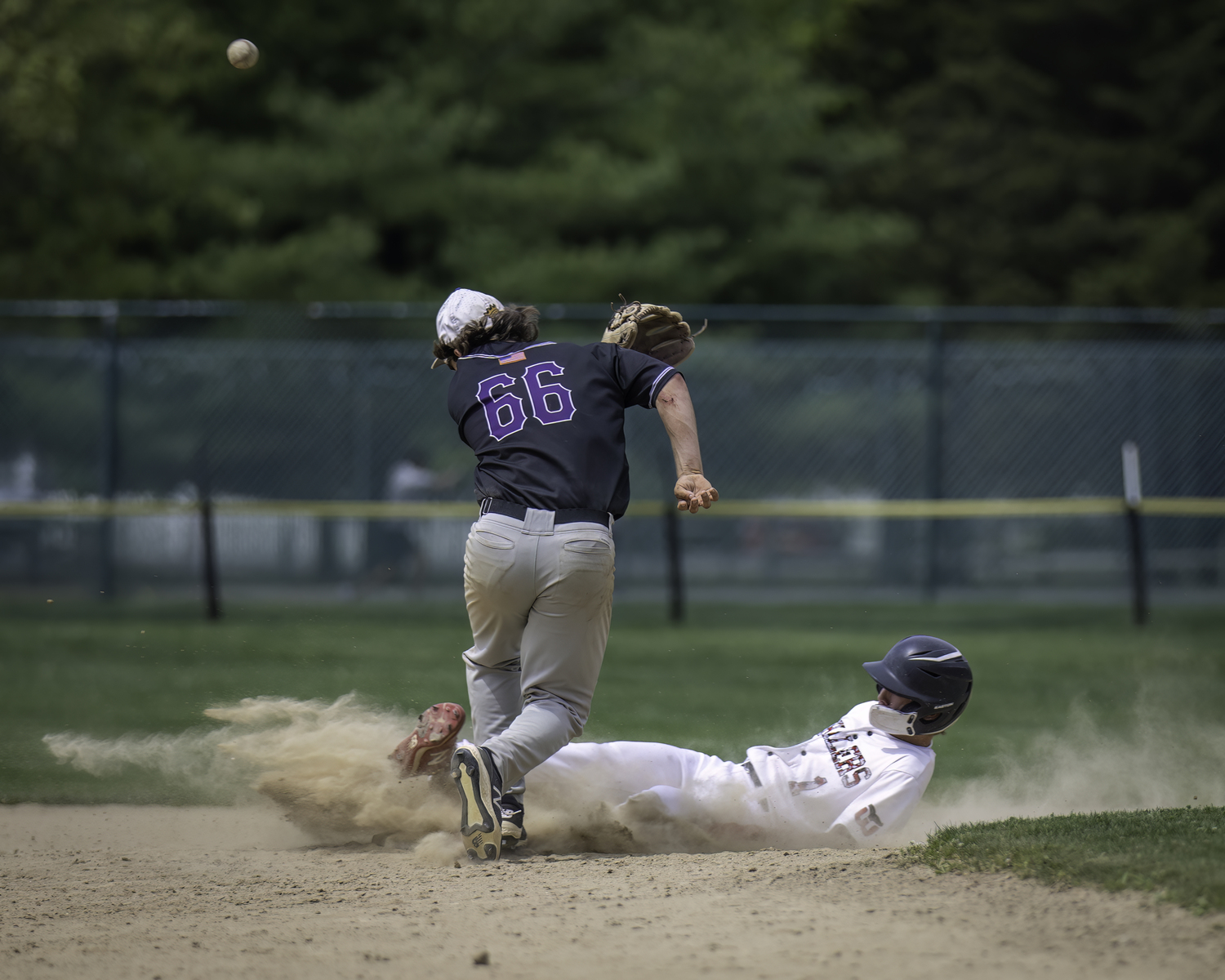 Pierson junior Dominick Mancino slides into second base as the ball gets away from a Port Jeff player.   MARIANNE BARNETT