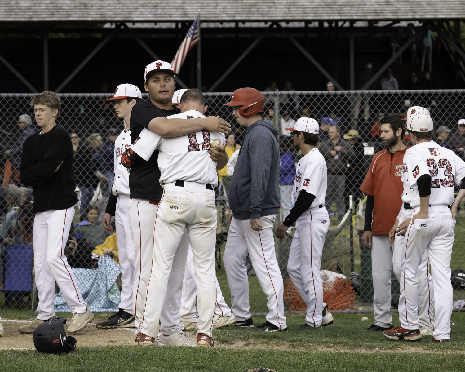 Pierson assistant coach Tyler LaBorne consoles Gavin Gilbride after the final out of Friday's loss to Port Jefferson.   MARIANNE BARNETT