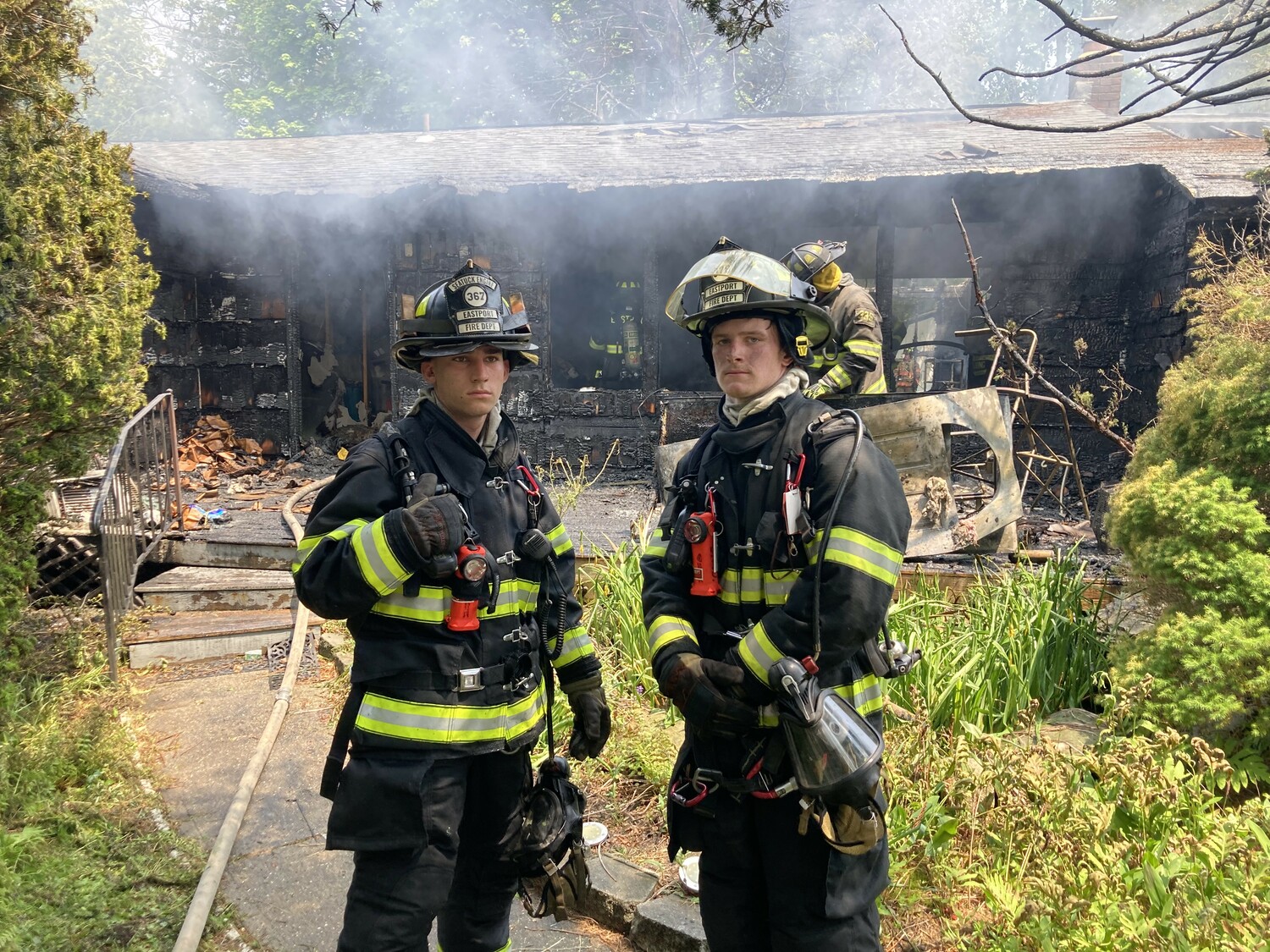 Firefighters fire fighters Mathew Meyer And Mathew Geire from the Eastport Fire Department on the scene of the blaze in Remsenburg.   COURTESY EASTPORT FIRE DEPARTMENT