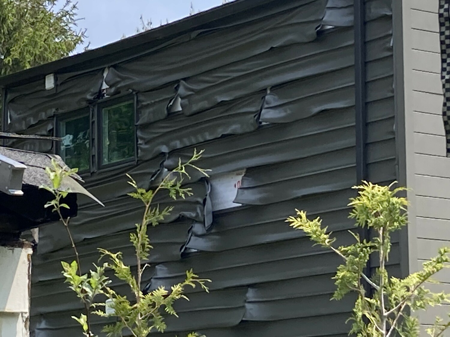 Heat from the fire on Shore Road in Remsenburg on May 24 was so intense, it melted the siding on a house next door.   COURTESY EASTPORT FIRE DEPARTMENT