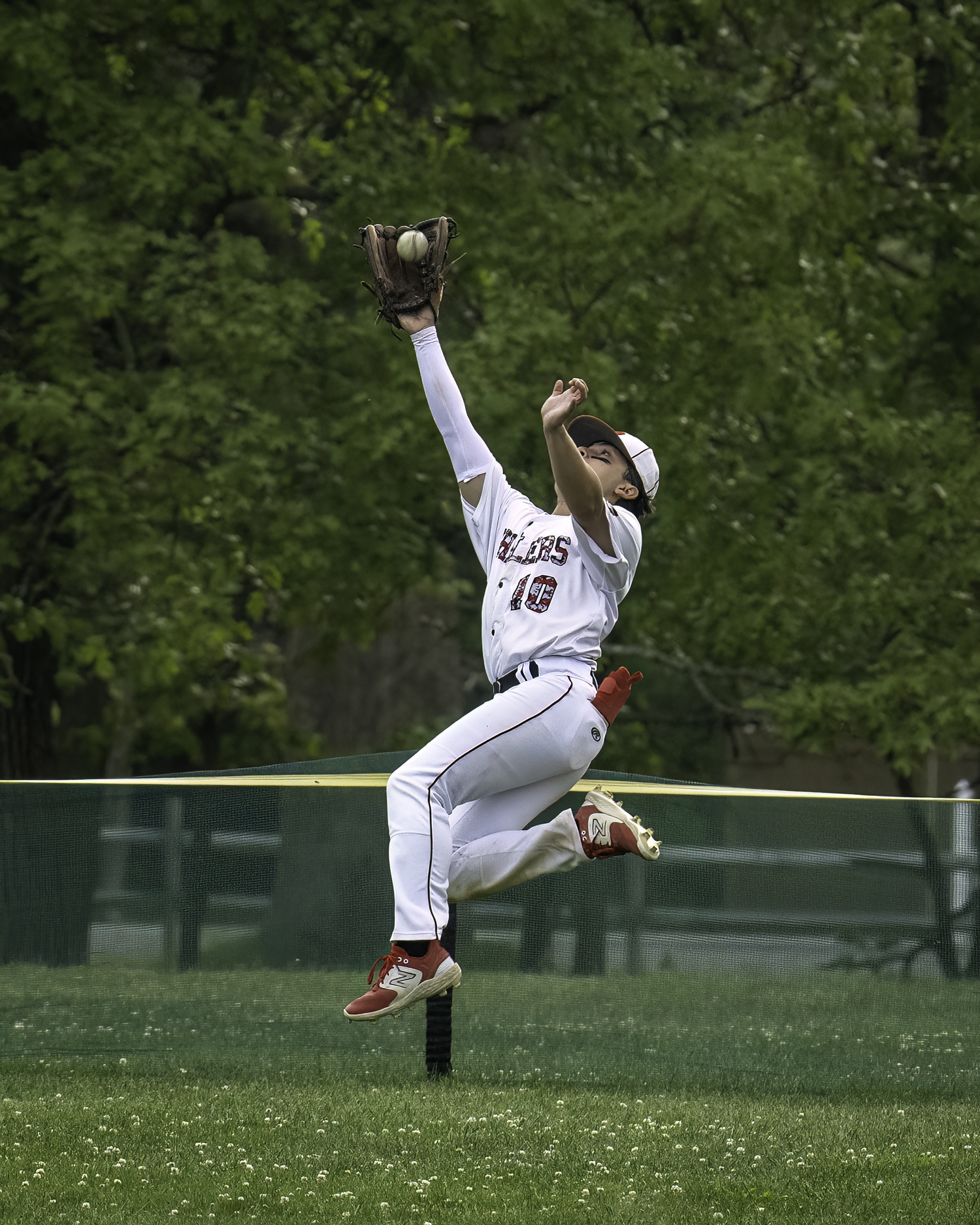 Whaler Max Krotman leaps and makes the catch in right field.   MARIANNE BARNETT