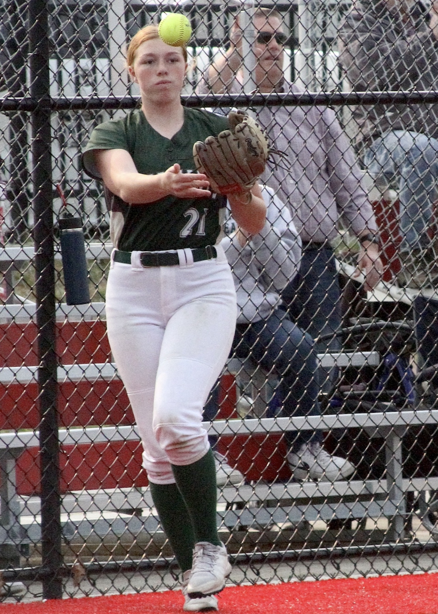 Freshman third baseman Katie Burke tosses the ball in after making a grab in foul territory for an out. DESIRÉE KEEGAN