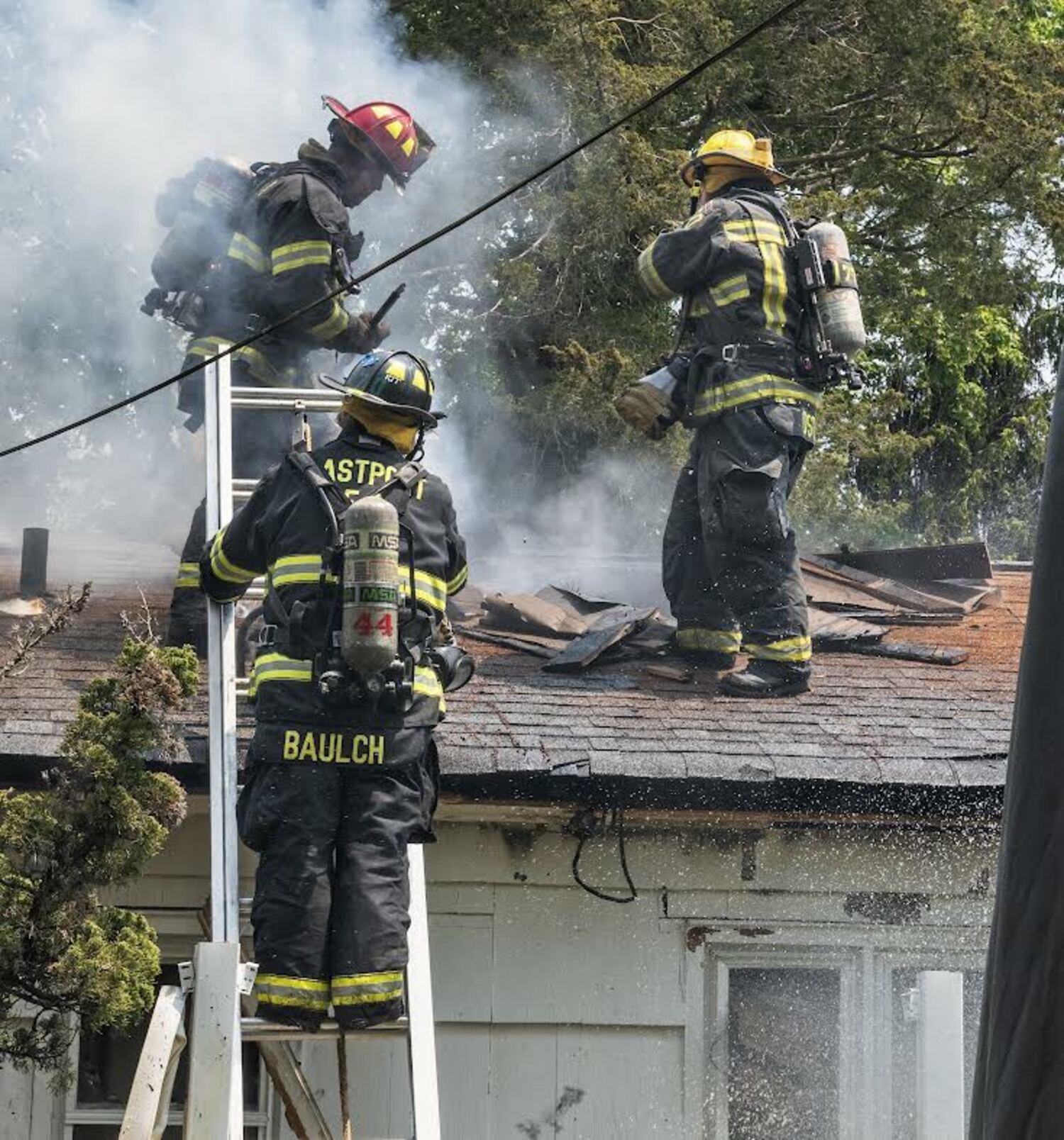Venting the roof at the fire that destroyed a home in Remsenburg on May 24.   COURTESY WESTHAMPTON BEACH FIRE DEPARTMENT.