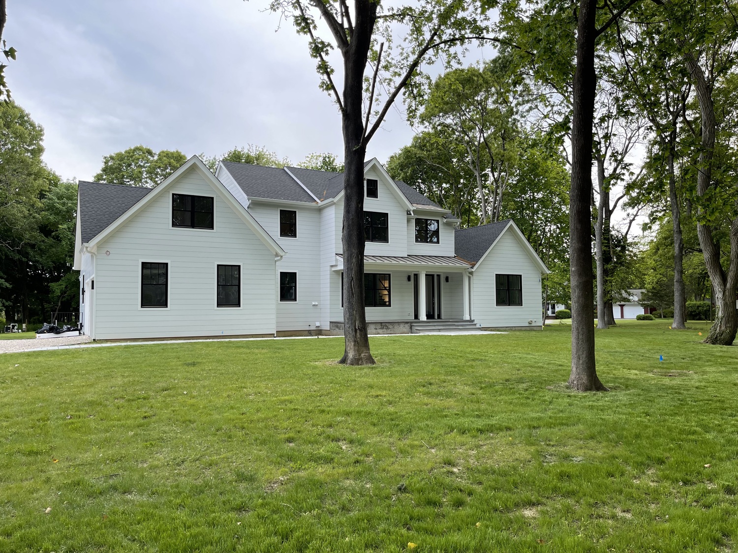 White house with black window frame. The true divided lites are invisible black on black. White shades would solve this problem. The house is occupied.
ANNE SURCHIN